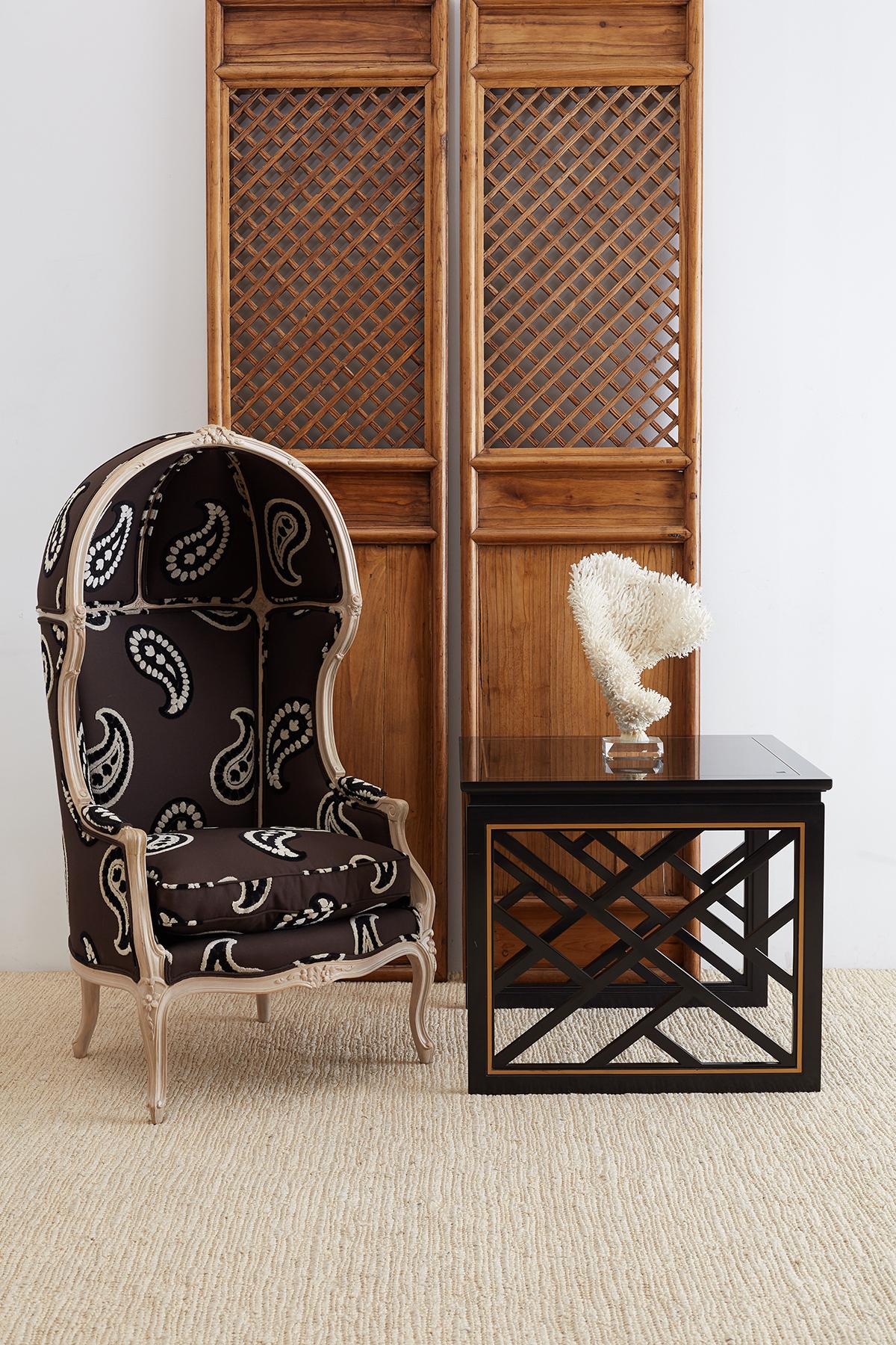 Pair of stunning black lacquered trellis tables by Carleton Varney for Kindel furniture. These fabulous tables feature Chinese Chippendale style geometric fretwork. Lattice panels on the sides with a gilt accent on the border. The open sides have an