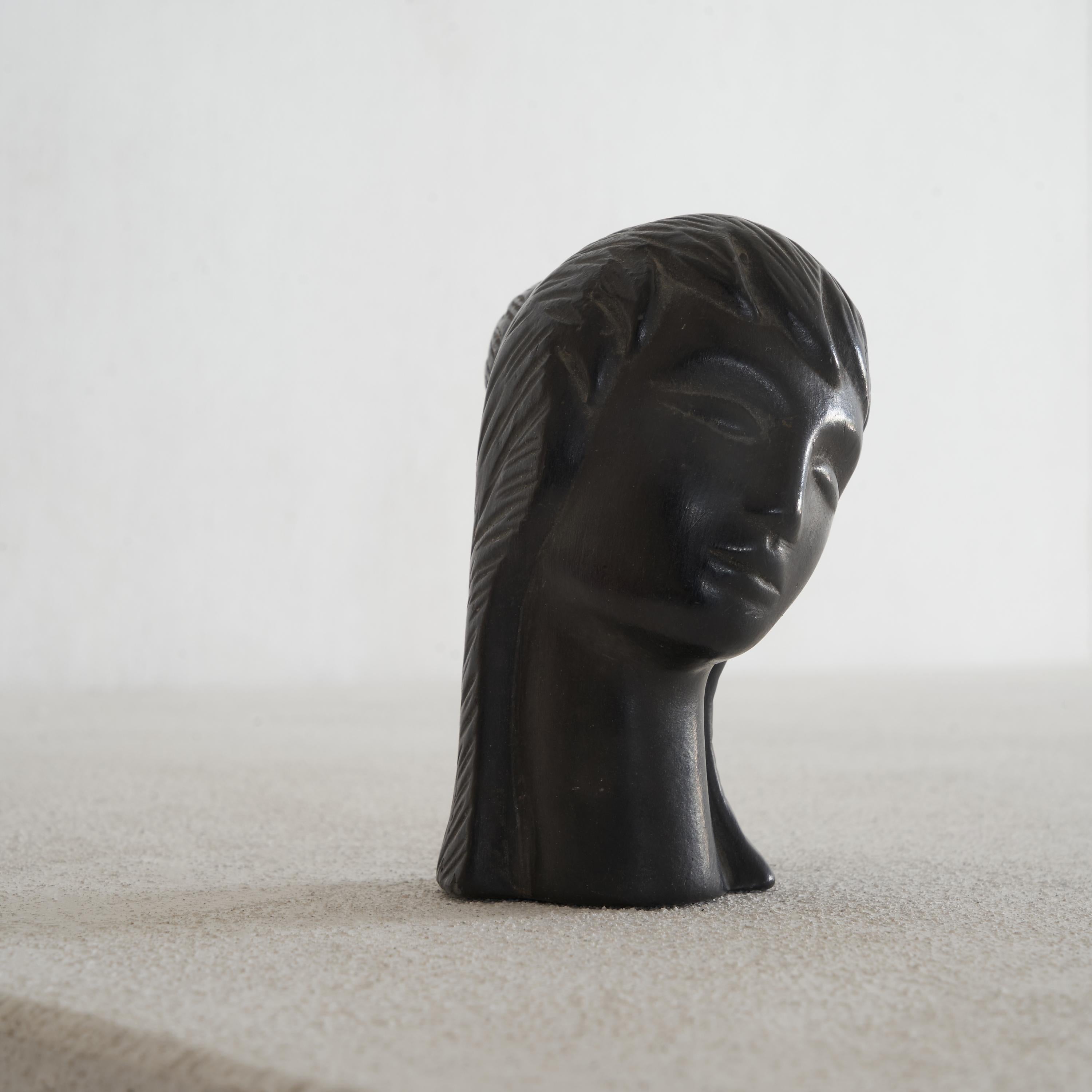 This is a rare and marvelous little mid century ceramic head by Carlo Alberto Rossi after a design attributed to Giò Ponti. Very stylistic and interesting sculpture. Although it is small, this head is a real conversation piece to sit on your desk or
