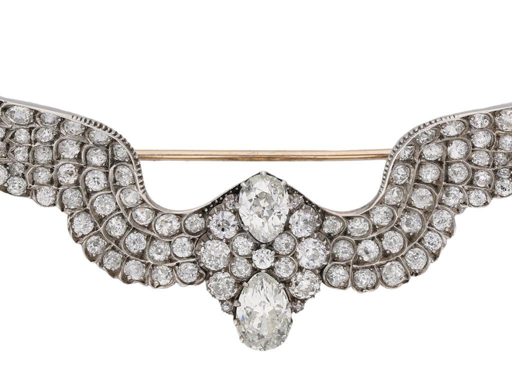 Antique diamond wing brooch, attributed to Carlo and Arthur Giuliano, circa 1900. A gold and silver brooch in the form of a pair of outstretched wings, the wings with one hundred and sixteen pavé set round old cut diamonds with an approximate total