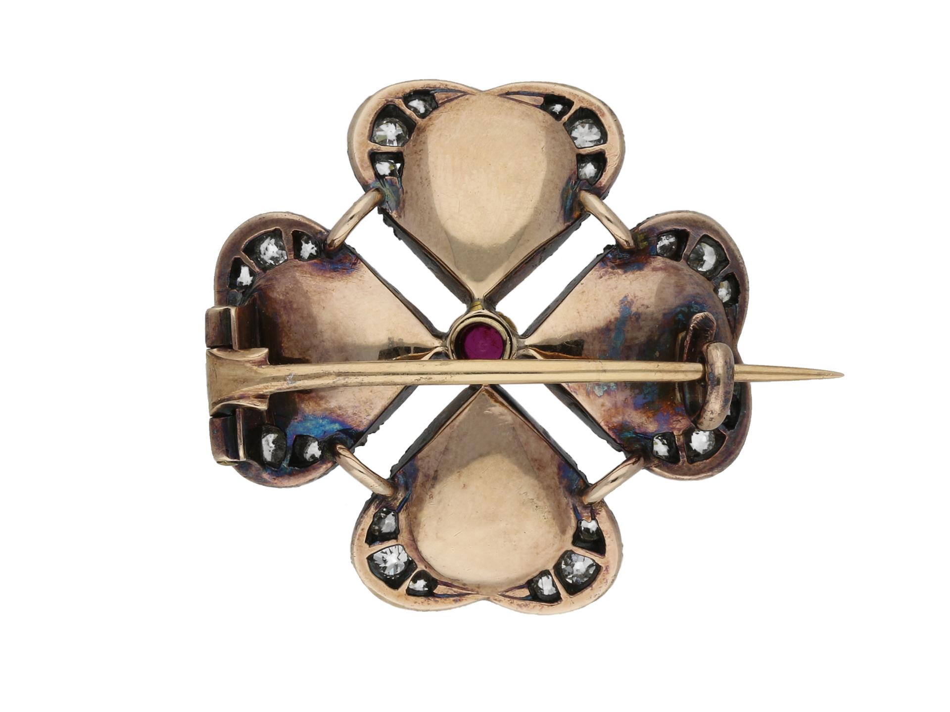 Moonstone, diamond and ruby cabochon brooch by Carlo & Arthur Giuliano, circa 1890. Four large drop shaped moonstone cabochons with an approximate combined weight of 10.00cts, in a quatrefoil setting with six round old cut diamonds to each outer