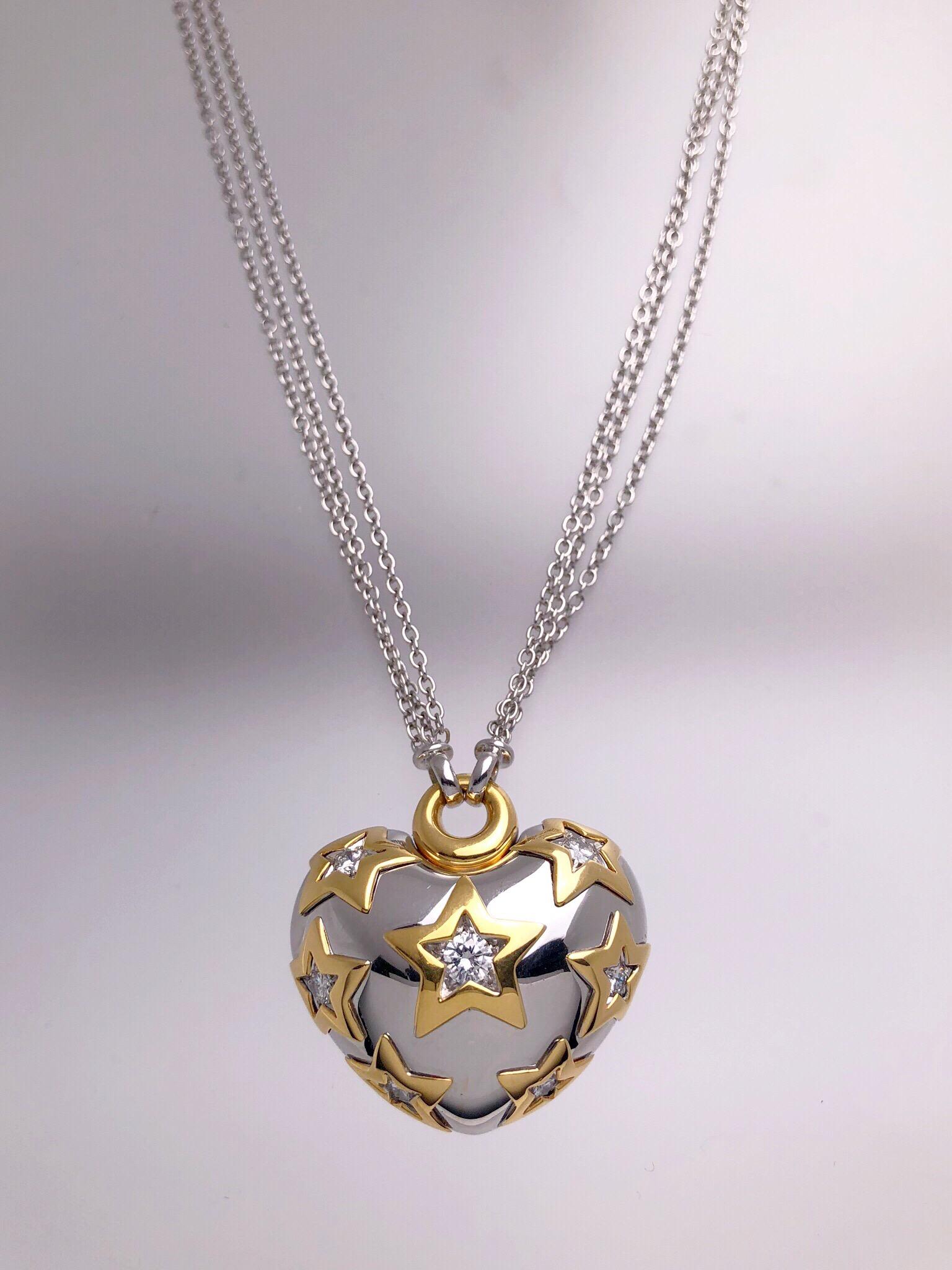 This stunning puffed heart pendant was crafted by Italy's renowned Carlo Barberis known for his creativity and elegant touches of fantasy. Set in 18 karat white gold this pendant features .93 carats of round brilliant diamonds outlined with 18 karat