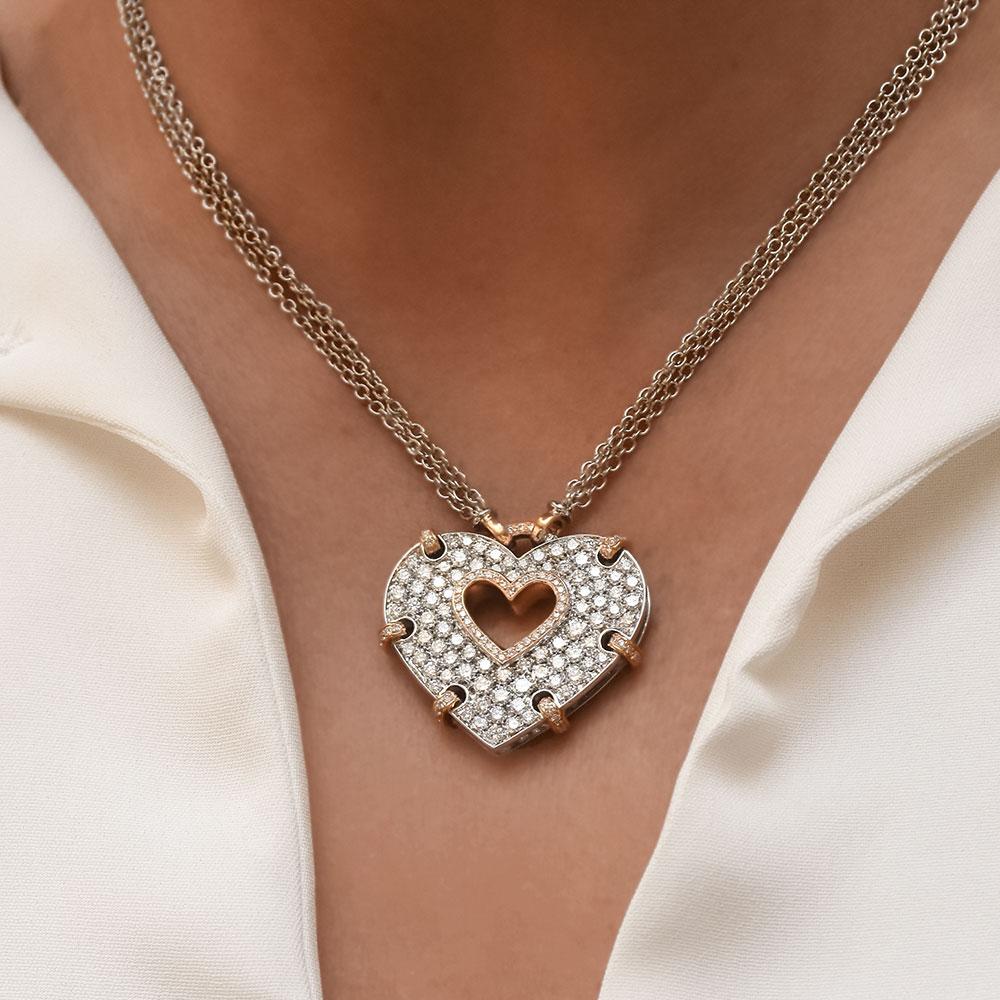 This stunning heart pendant was crafted by Italy's renowned Carlo Barberis known for his creativity and elegant touches of fantasy. Set in 18 karat white gold this pendant features 3.00 carats of round brilliant cut diamonds. The center of the heart
