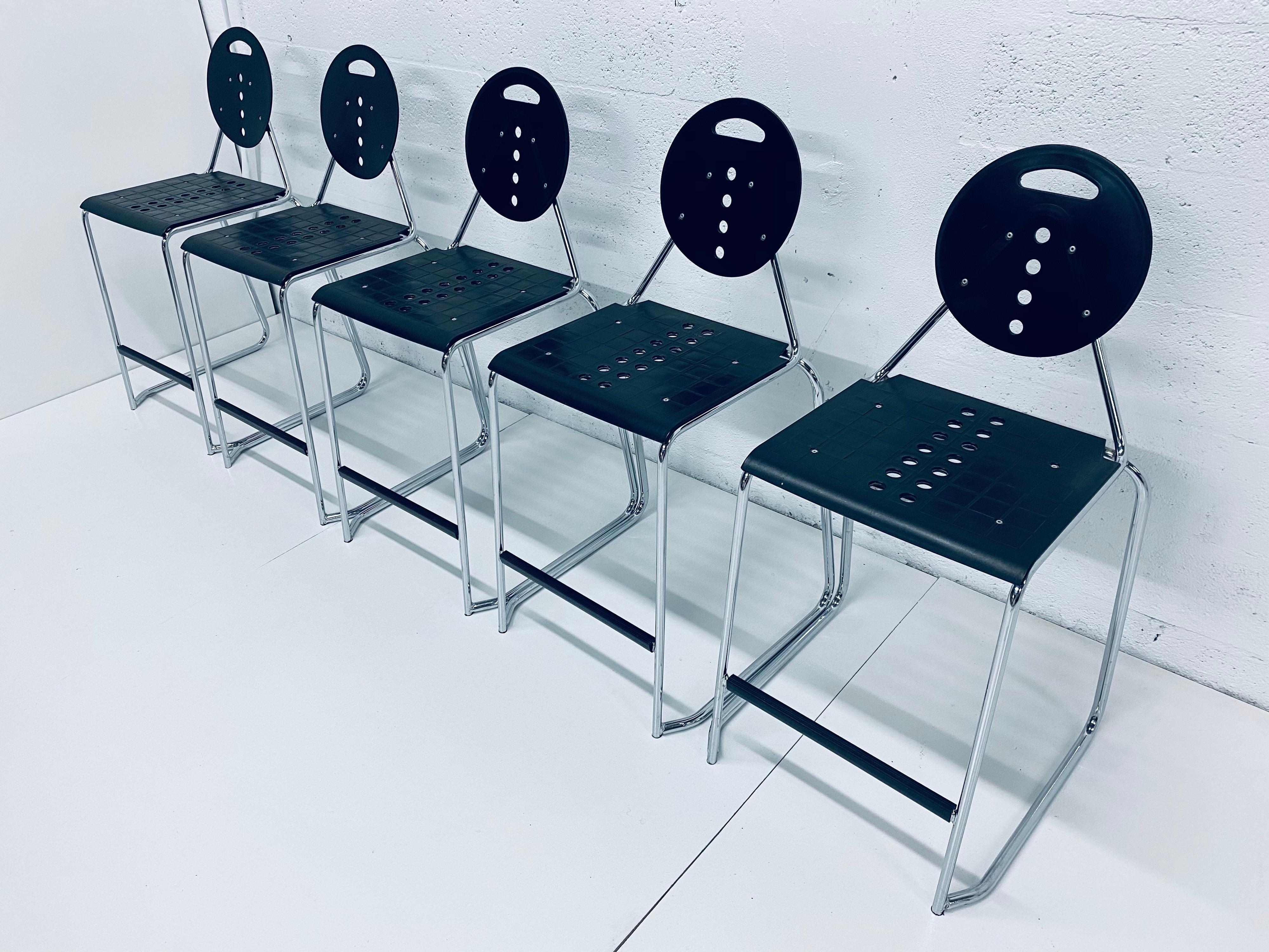 Set of 5 Postmodern Memphis style barstools by Carlo Bimbi and Nilo Gioacchini for Segis Italia, circa 1980s. Chairs are made of black moulded plastic attached to a tubular chrome frame. The chairs stack for easy storage.