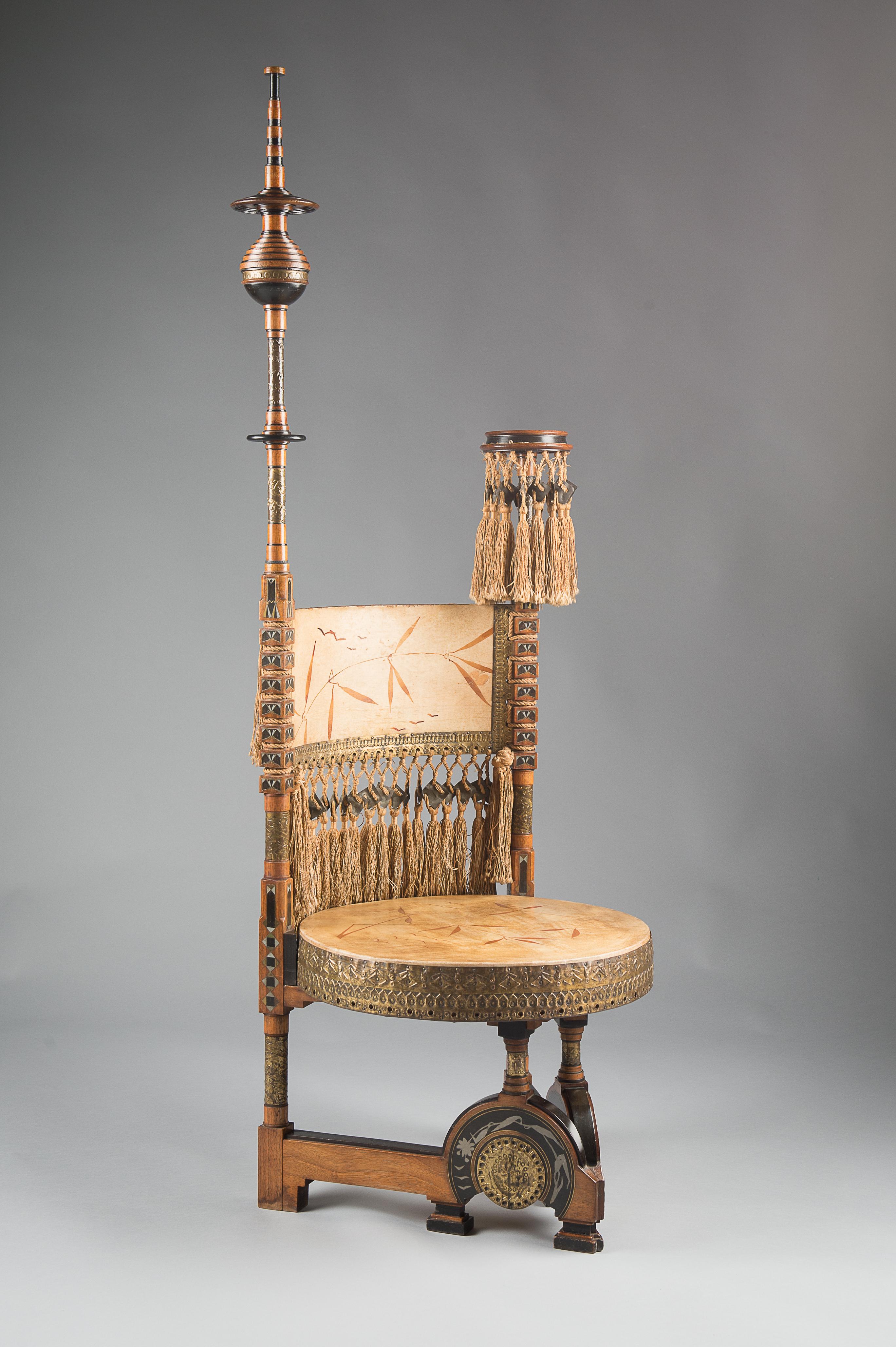 An important circular seated walnut throne chair. Consisting of calf vellum seat and hand painted illumination, inlaid with Pewter and Brass and applied hand beaten copper. Original silk tassels and an original Bugatti label from Milan.
Featured in