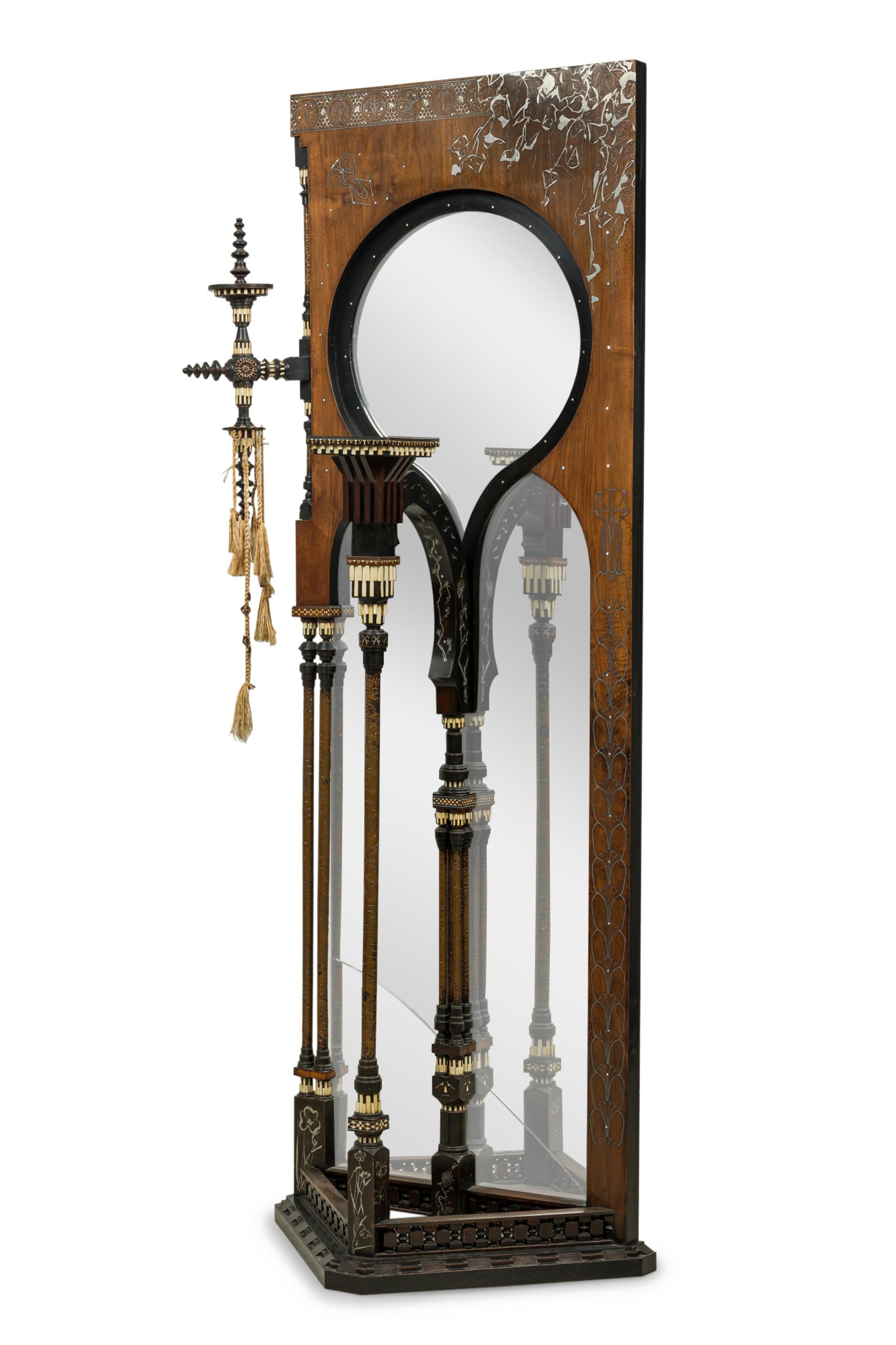 Italian Art Nouveau narrow hall / hatrack stand having a walnut & ebonized wood frame with pewter & pearl inlay and a shaped inset full-length mirror,with elaborate columns and center pedestal having copper veneer, featuring elaborate geometric bone
