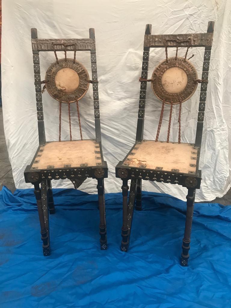 Pair of Moorish style chairs in stained walnut designed by Carlo Bugatti, circa 1900. Chair inlaid with star motif, beaten copper and bone. The seat and the drum-shaped slab are made of parchment.
Original condition with stains, scratches and wear