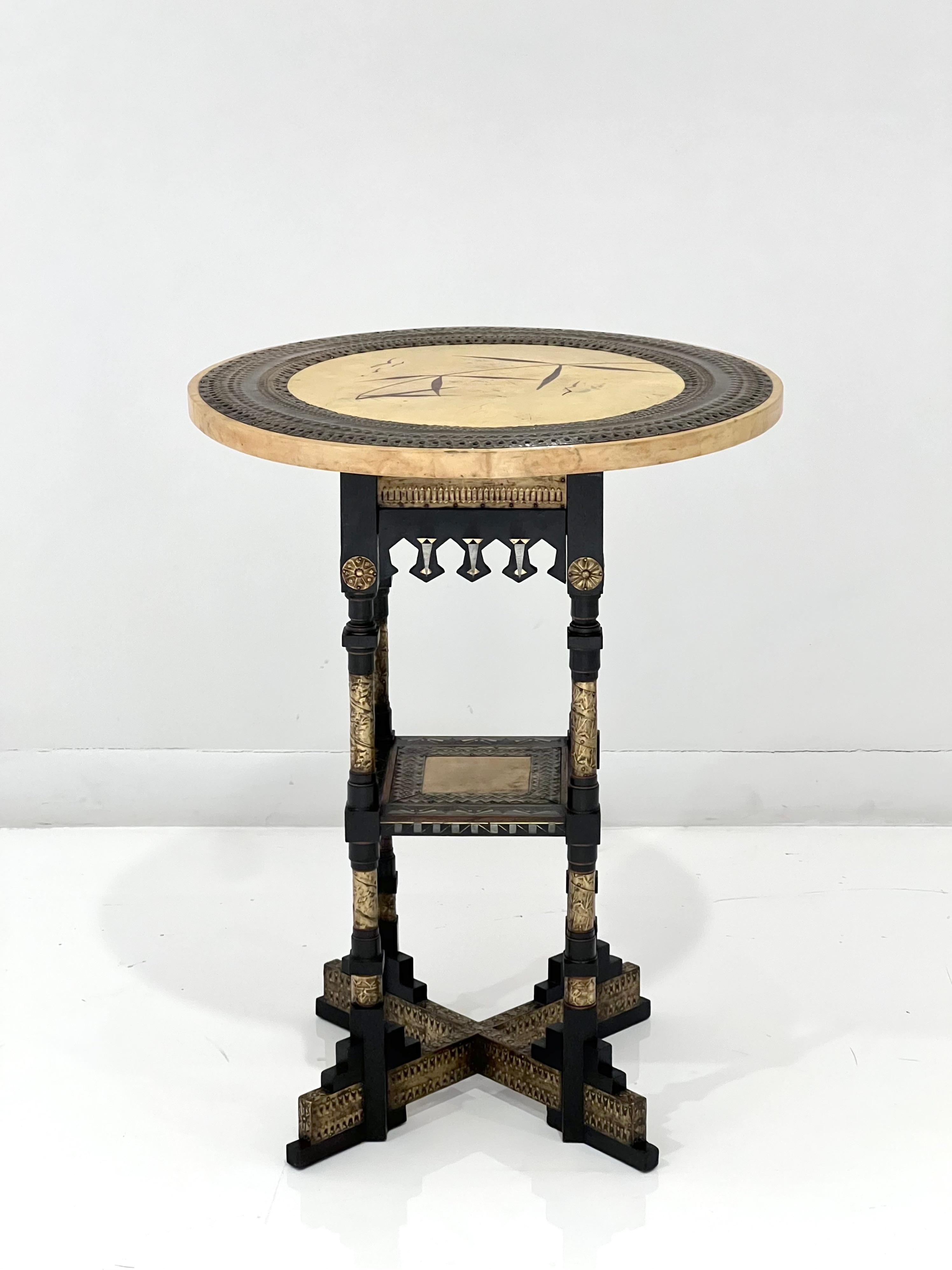 Stunning Carlo Bugatti parchment side table. Italy, circa 1890. Mahogany, ebonized woods, brass, pewter, parchment with birds and foliage motifs.