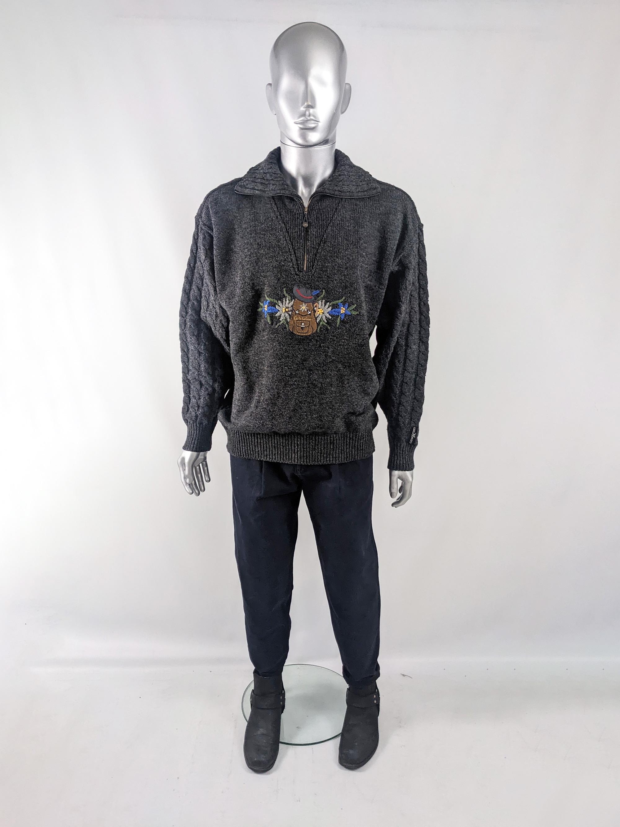 An amazing vintage mens sweater from the 80s by luxury Italian knitwear label, Carlo Colucci. In a grey wool-rich knit fabric with a zip collar, Austrian style embroidery with a suede patch on the front and cable knit sleeves and back.

Size: Marked
