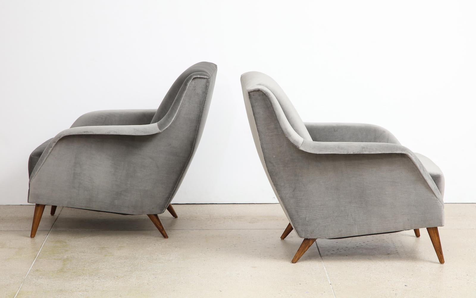 Pair of #802 lounge chairs by Carlo De Carli for Cassina. Sculptural upholstered seating with ashwood conical legs. Recently reupholstered in gray velvet.
