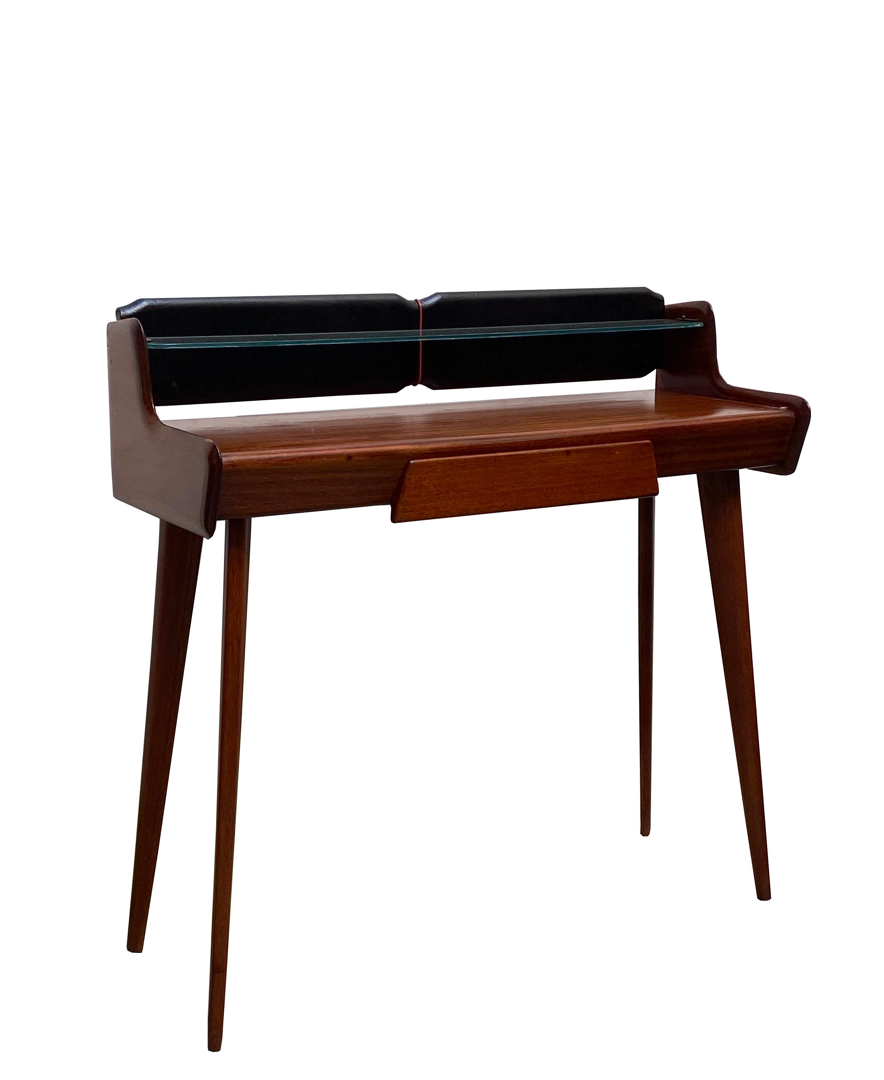 Beautiful mid-century Italian wooden console table by Carlo di Carli. There is a central drawer and a glass shelf on each piece.