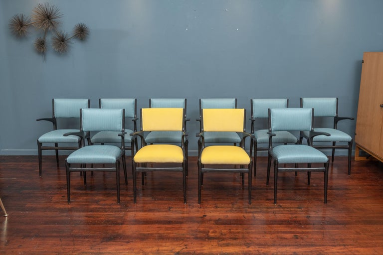 Mid-century Italian dining chairs designed by Carlo de Carli for Cassina, Italy. Set of 10 armchairs newly upholstered and ready to install. Ebonized finish in very good condition with edge wear to the front of arms but all frames are stable and