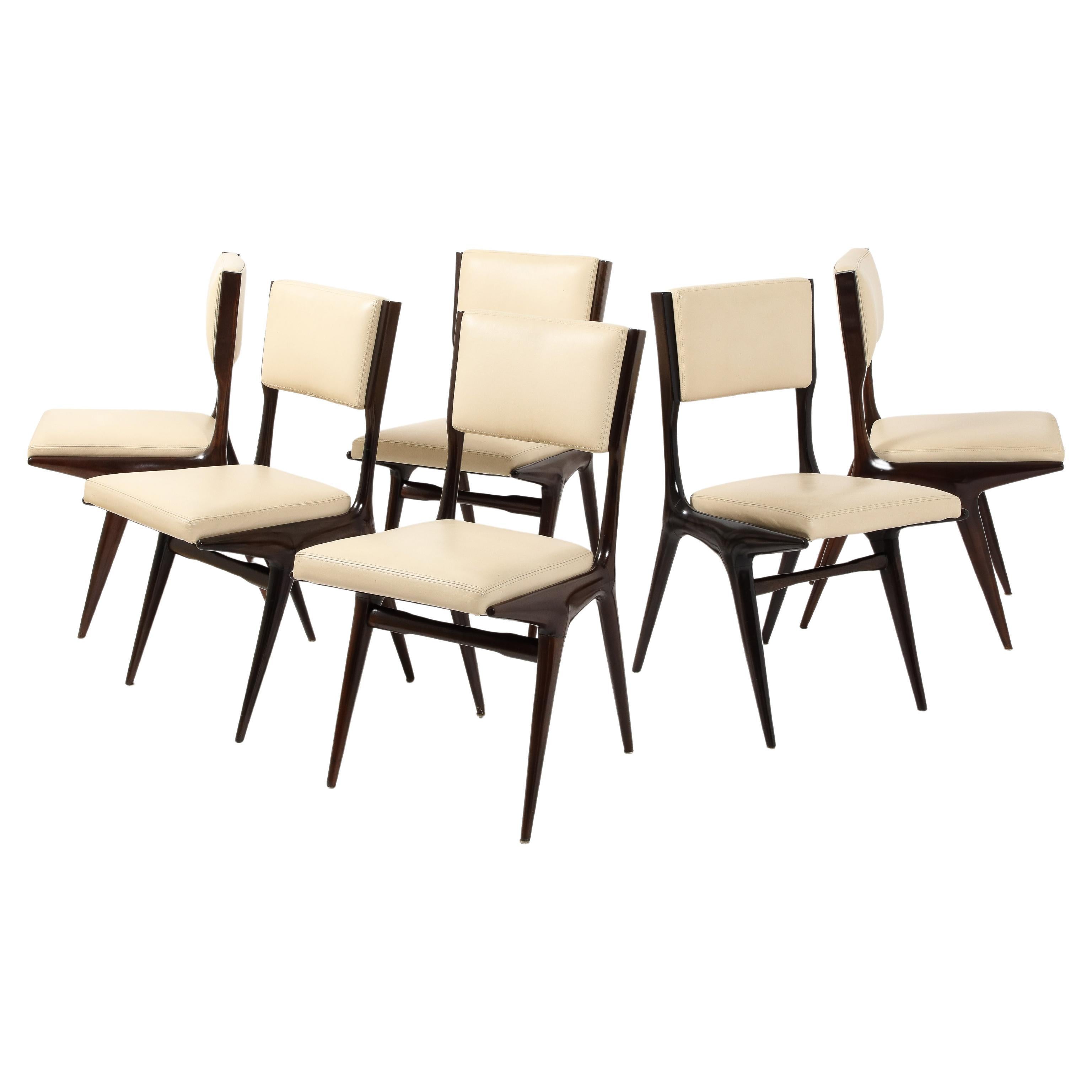 An early set of six Carlo de Carli N63 chairs in a dark finish, reupholstered in leather in early 2000. COM is available on request.