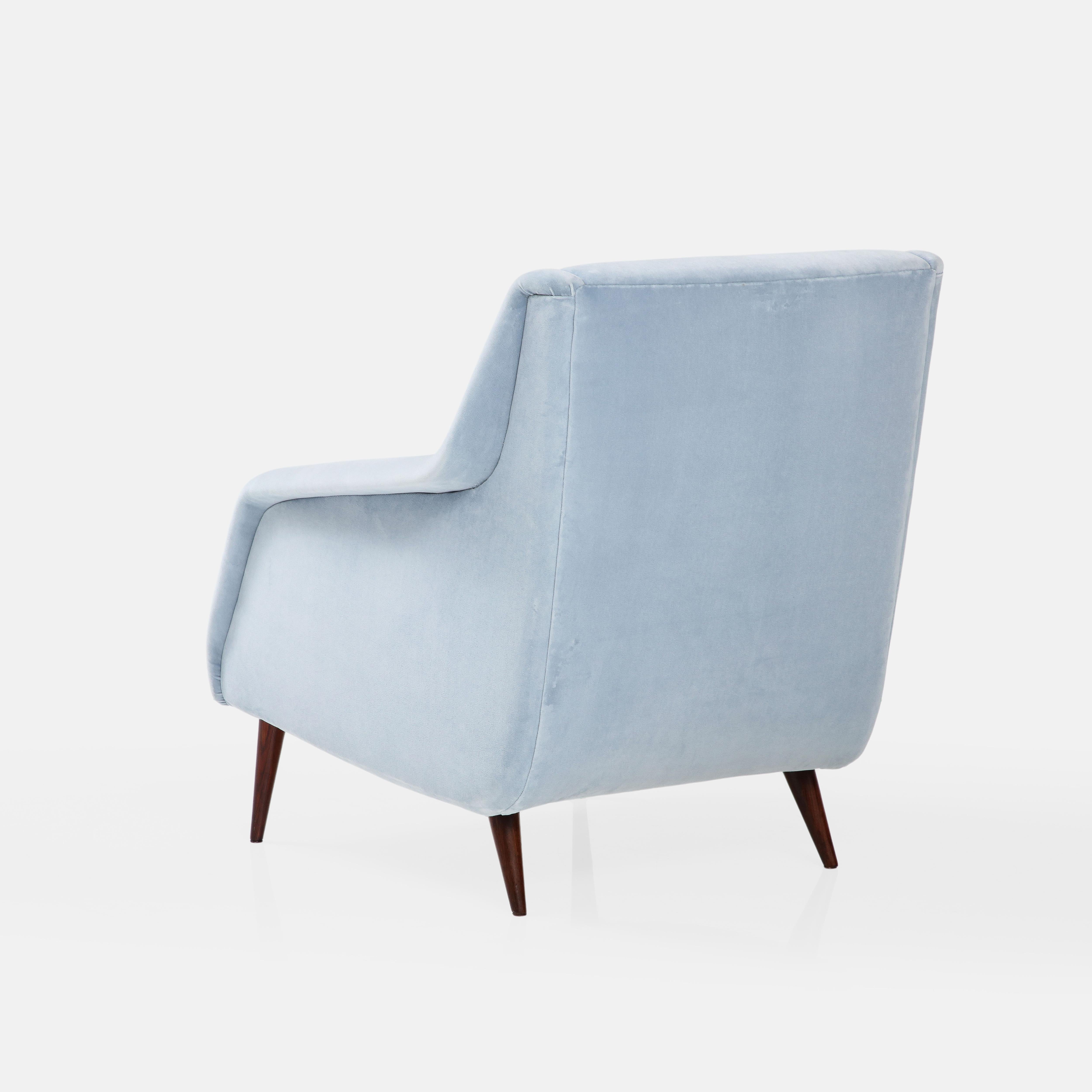 Carlo De Carli for Cassina sculptural lounge chair or armchair in light blue velvet upholstery with stained wood legs. These armchairs are an iconic 1st edition Carlo De Carli design with sleek architectural lines and great proportions for