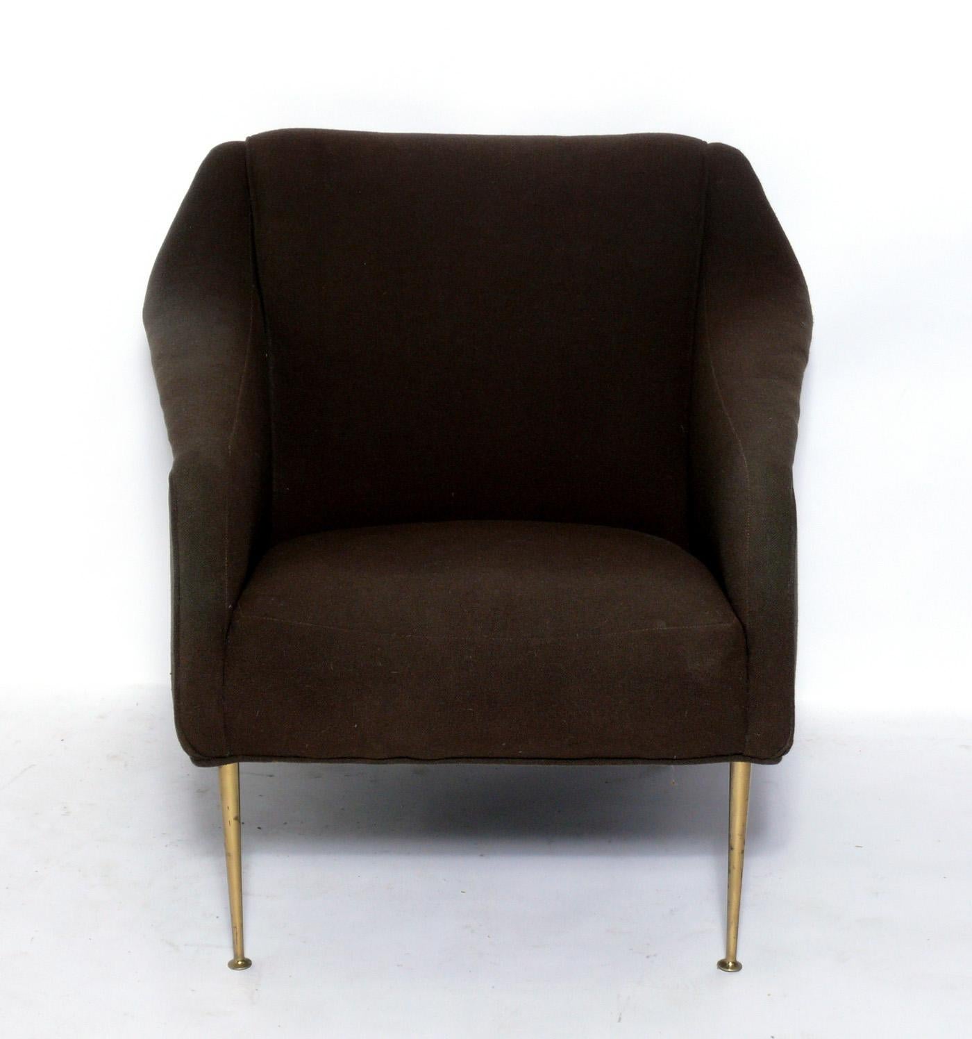 Elegant Mid-Century Modern lounge chair, designed by Carlo de Carli, Italian, for Singer and Sons, American, circa 1950s. It retains it's original upholstery, which is in decent condition if you like vintage fabric. However, we recommend