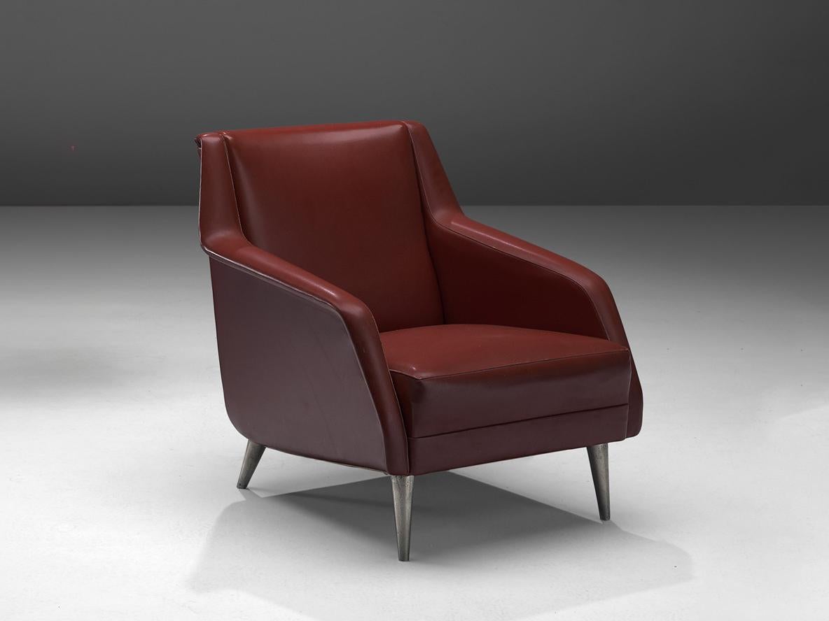 Carlo de Carli for Cassina, lounge chair, model 802, leatherette, nickel-plated metal, Italy, 1954

Carlo De Carli, a prominent Italian architect and designer, designed this elegant chair that dates back to the 1950s. The chair features a sleek,
