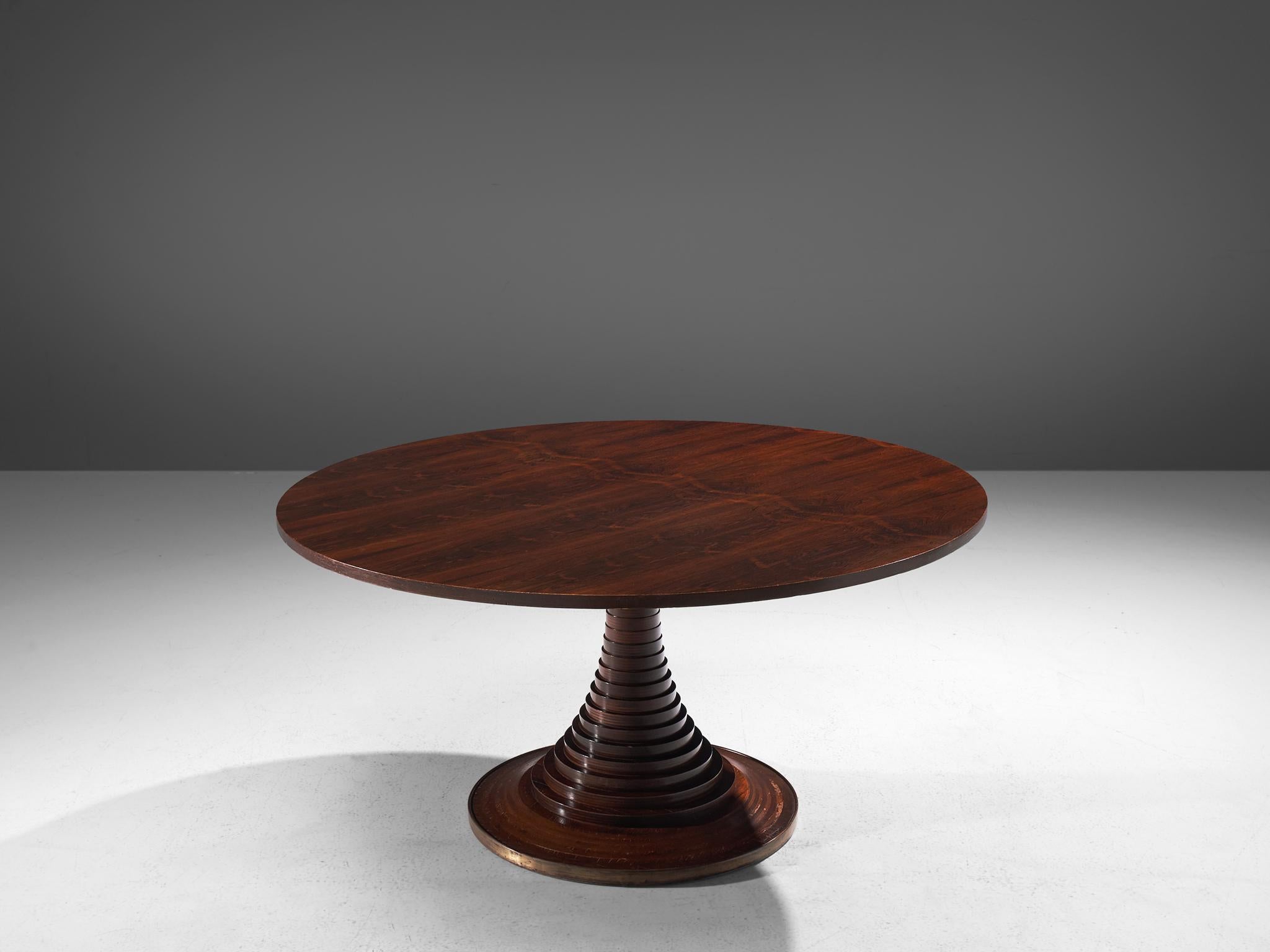 Carlo de Carli, dining table model 180, rosewood, laminated wood and brass, Italy, circa 1964.

Beautiful and monumental dining table, designed by Italian designer Carlo de Carli in circa 1964. The table features a circular tabletop in rosewood and