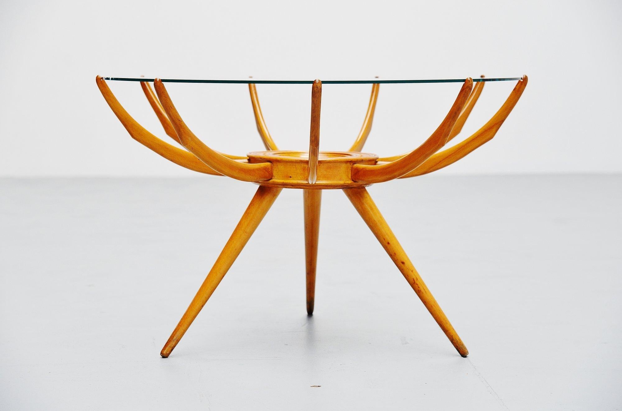 Extraordinary shaped Ragno ( = spider) side or coffee table designed by Carlo de Carli, Italy 1950. This table is made of birch wood and has a clear glass top. I don’t think we have to explain where the name Ragno comes from, the shape is very