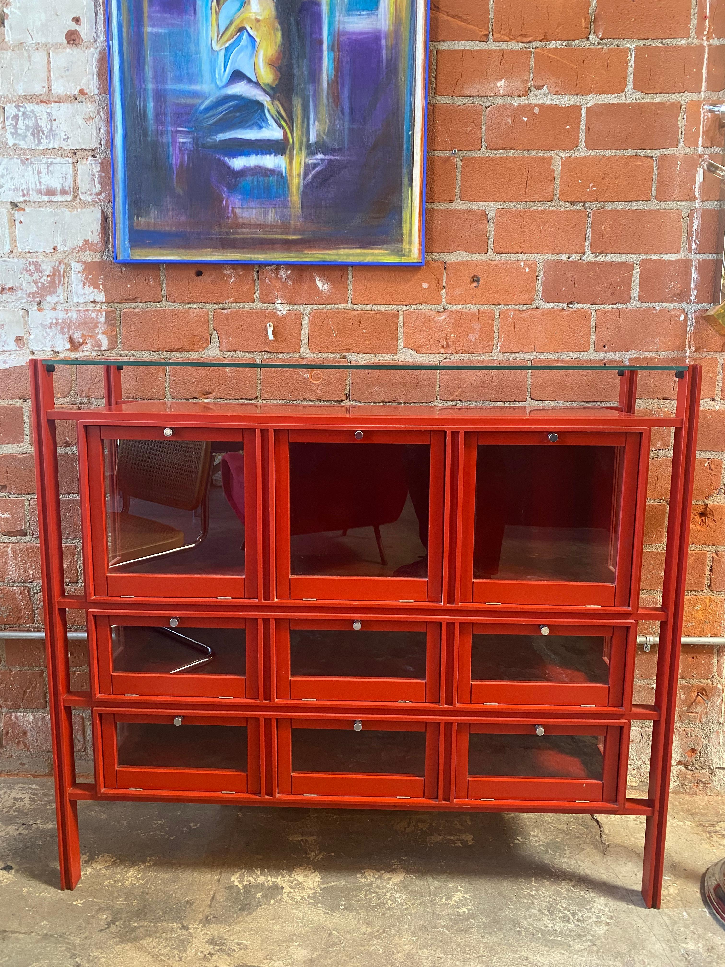 Extraordinary and rare Carlo de Carli Credenza/Cabinet with orthogonal frame in red lacquered wood, sides with transparent glass insert, flap doors with lacquered wood and crystal frame, upper top in ground glass. Year 1950. Original project for the