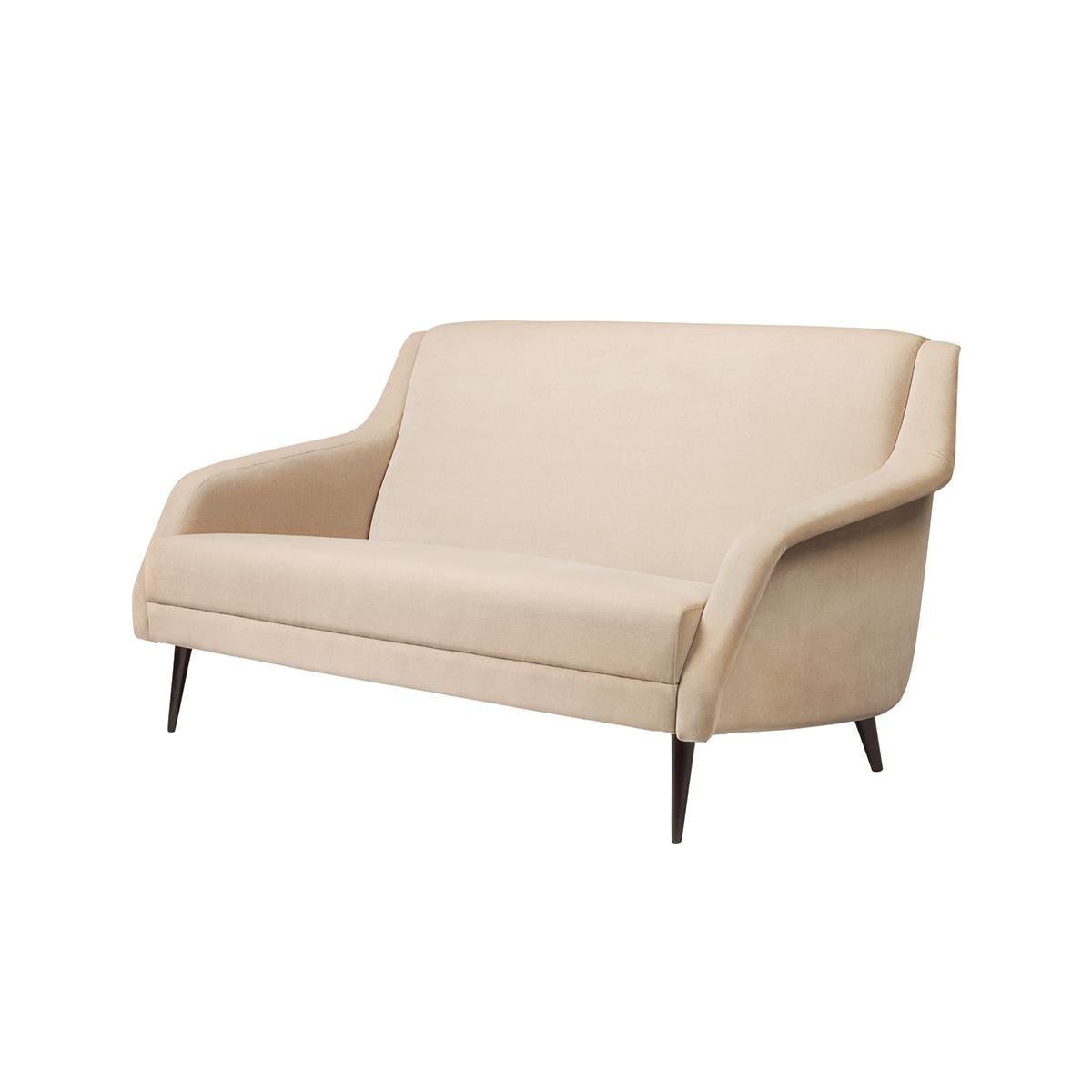 Sofa designed by Carlo de Carli in 1954, features the elegantly Minimalist design style, typical of the era.

The CDC.2 Sofa meets the ground in a graceful and slender way; its arms swooping like wings, giving the furniture a sense of poetic