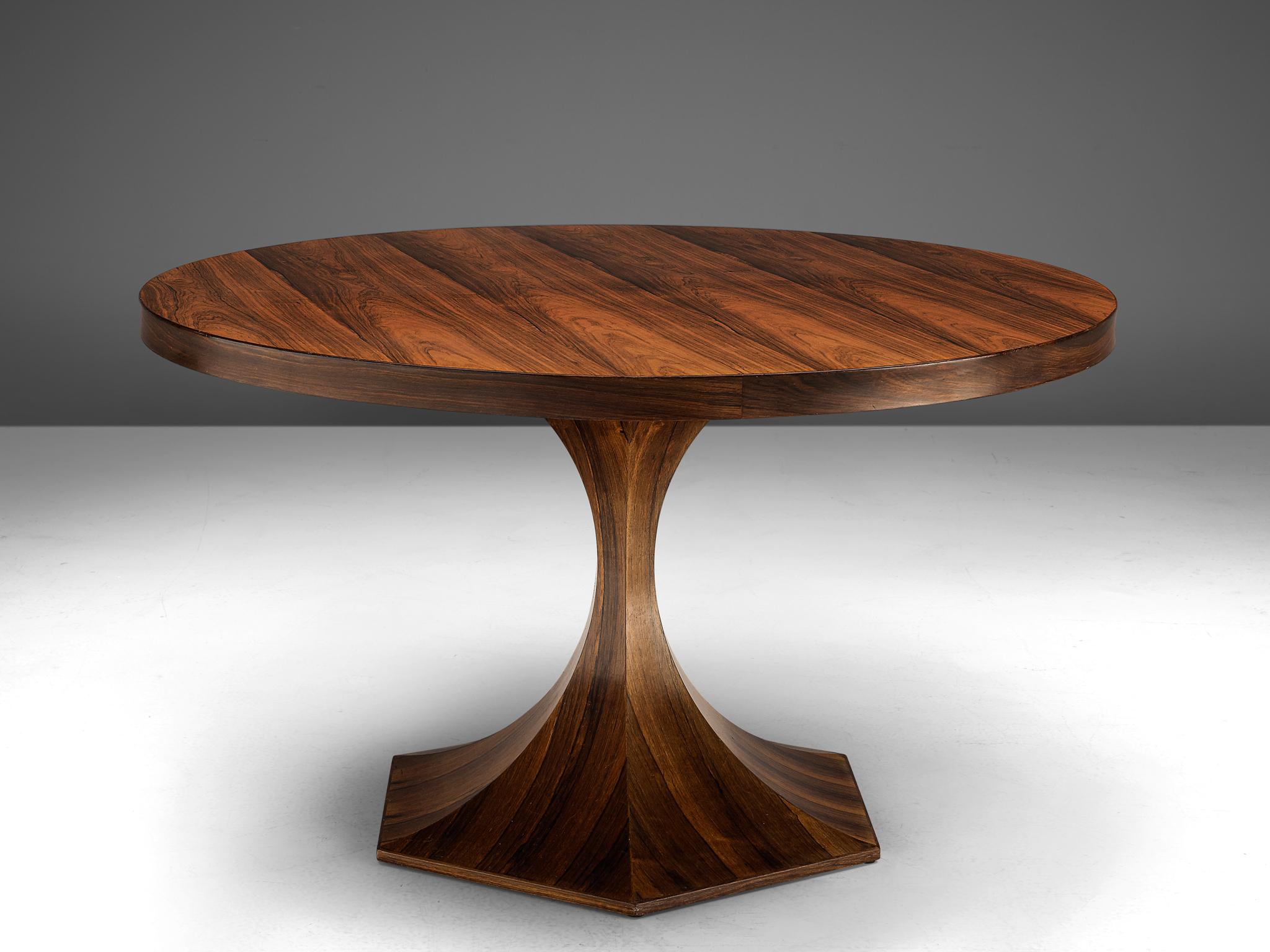 Carlo de Carli, round dining table, rosewood, Italy, circa 1950.

This circular table by Carlo de Carli features a slim, sculptural foot. The wooden grain has an admirable expression with dark grains that defines the aesthetics of this table. The