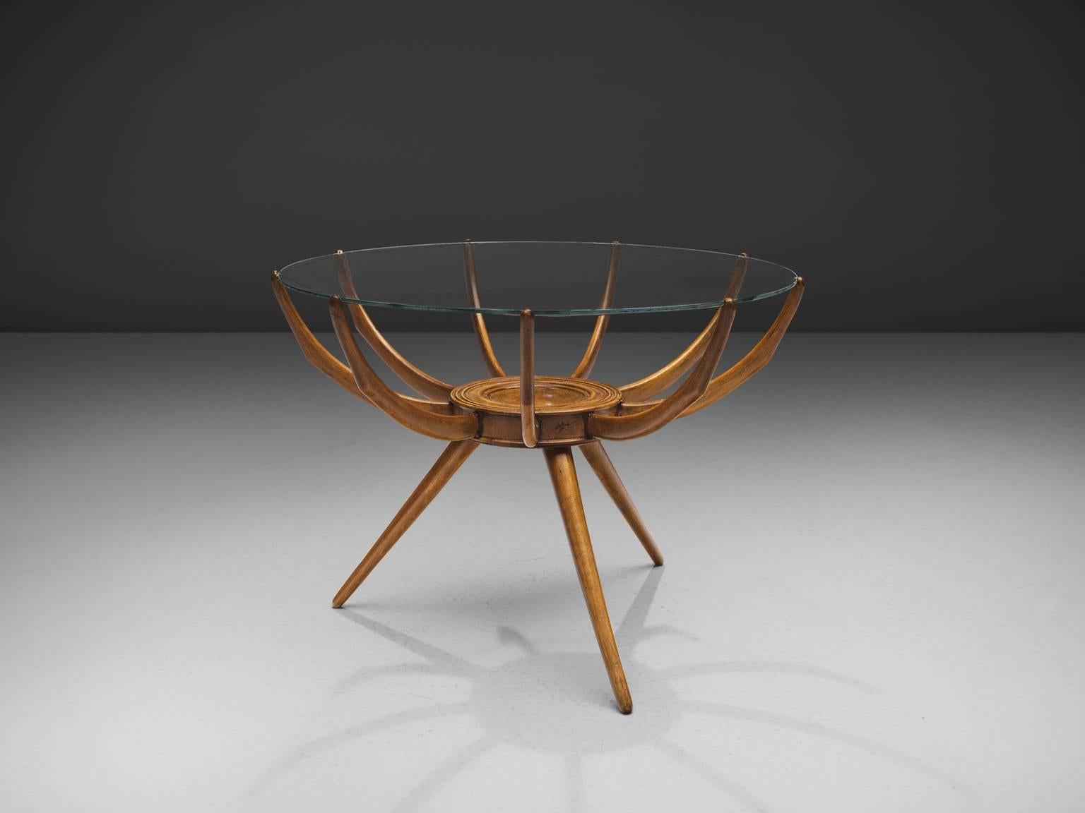 Carlo de Carli, Renato G. Angeli, and Luigi Claudio Olivier, coffee table, Italy, 1950s.

This is medium size coffee table is made out of beech wood, glass and metal. The top of the table is gently placed on the wooden arms which connect to the