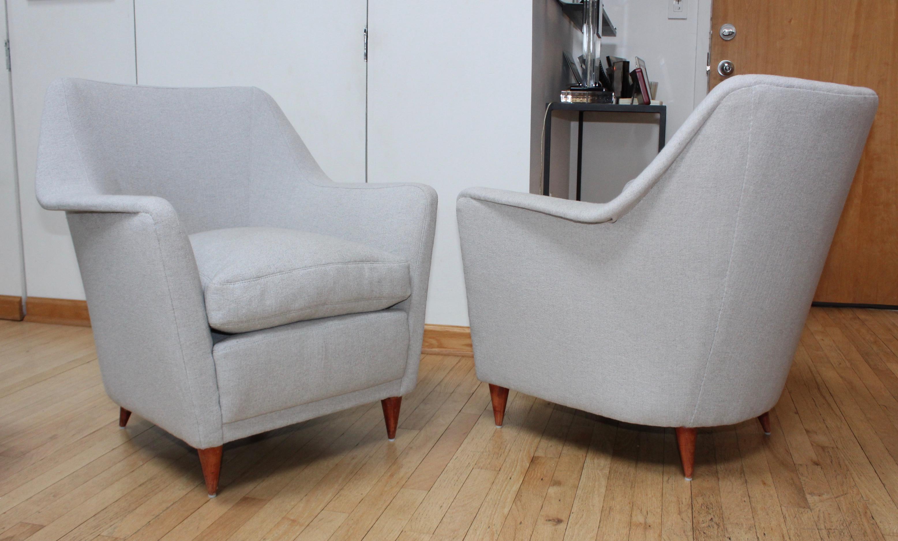 Stunning pair of 1950s Carlo de Carli style Italian lounge chairs. They were reupholstered 1 years ago with feather down seats.