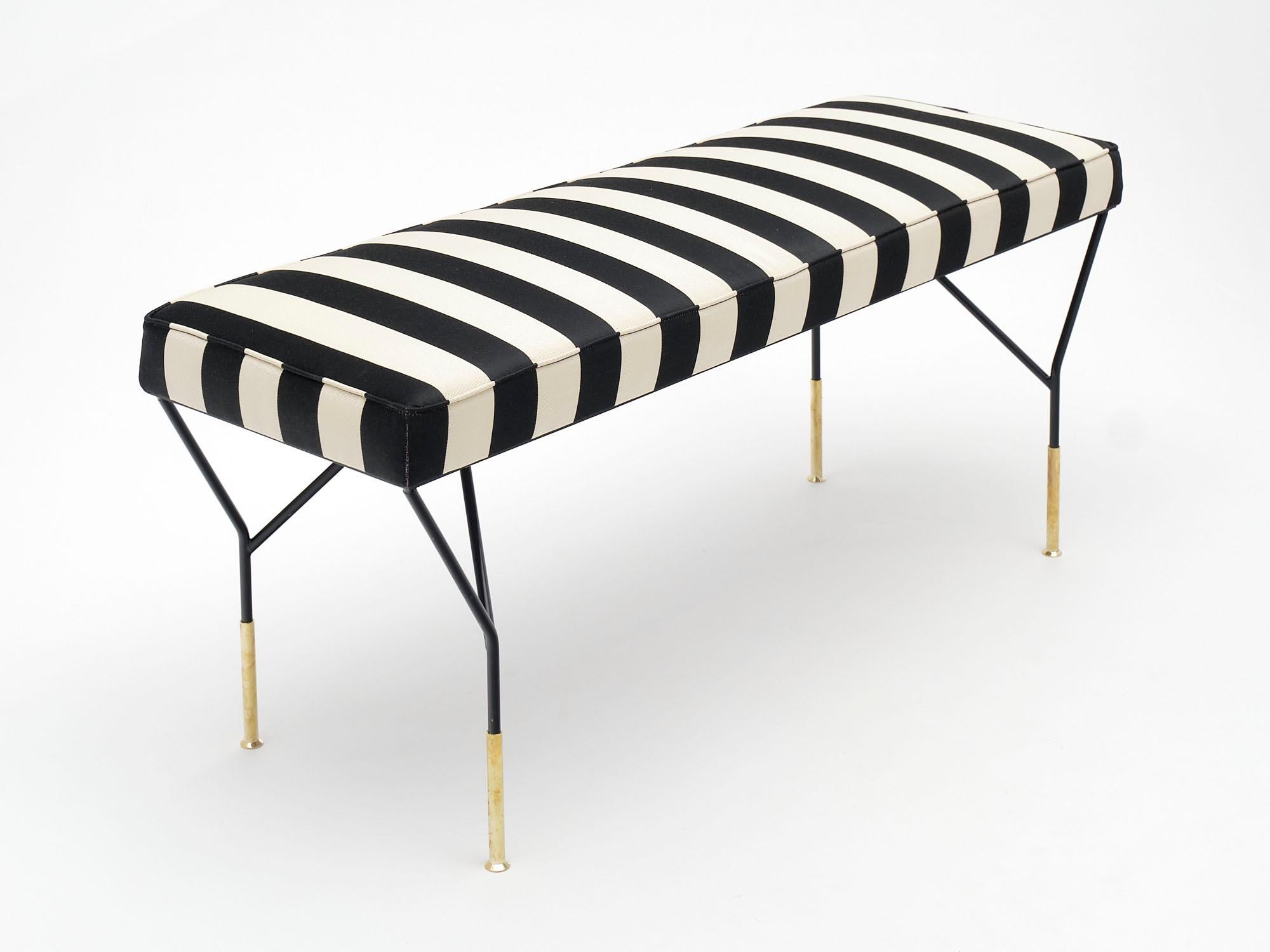 Pair of benches, Italian, vintage, of black lacquered steel and brass. New black and white striped upholstery.