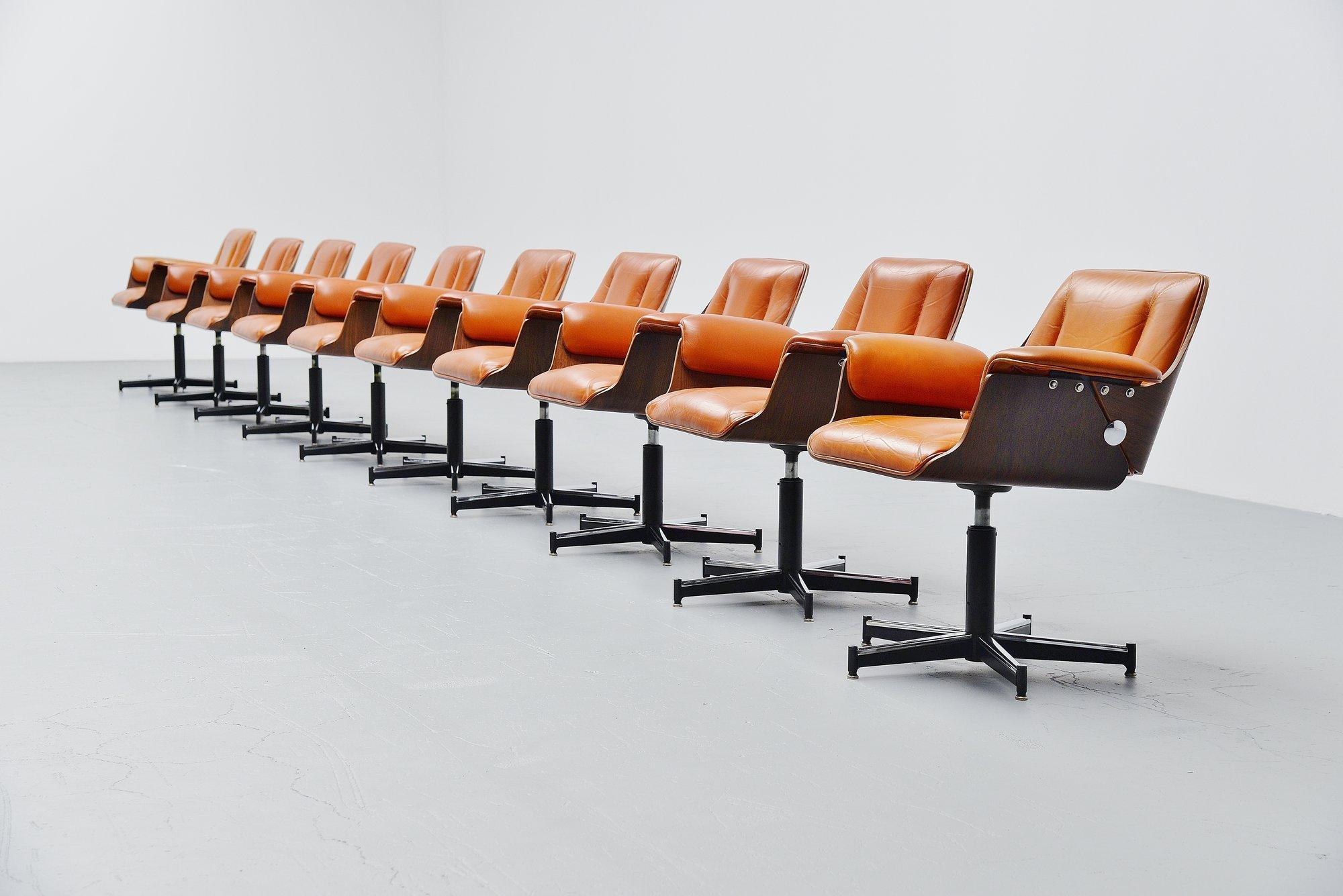 Fantastic set of ten Probjeto office chairs designed by Carlo B. Fongaro and manufactured by Dinamarquesa, Brazil, 1975. These chairs have splendid Brazilian rosewood shell seats with cognac colored leather upholstery. The chairs have black painted