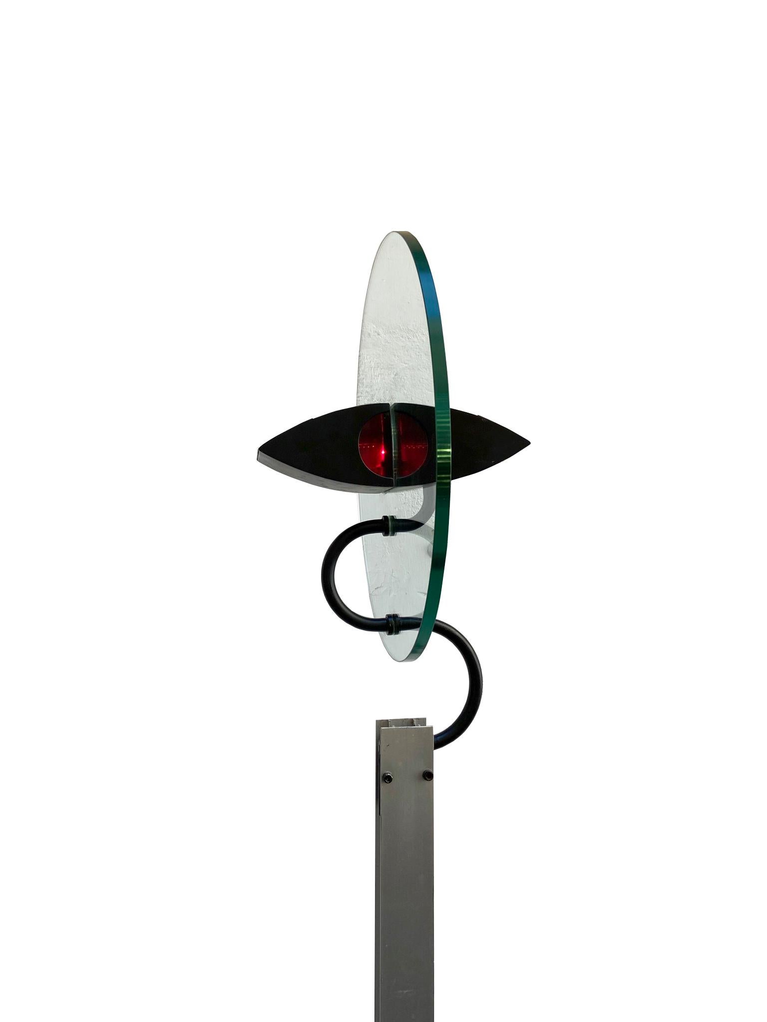 This sculptural floor lamp model Olimpia takes inspiration from the design of the eye. It was designed by Carlo Forcolini and produced by Artemide. It comes from the first series of Olimpia lamps.