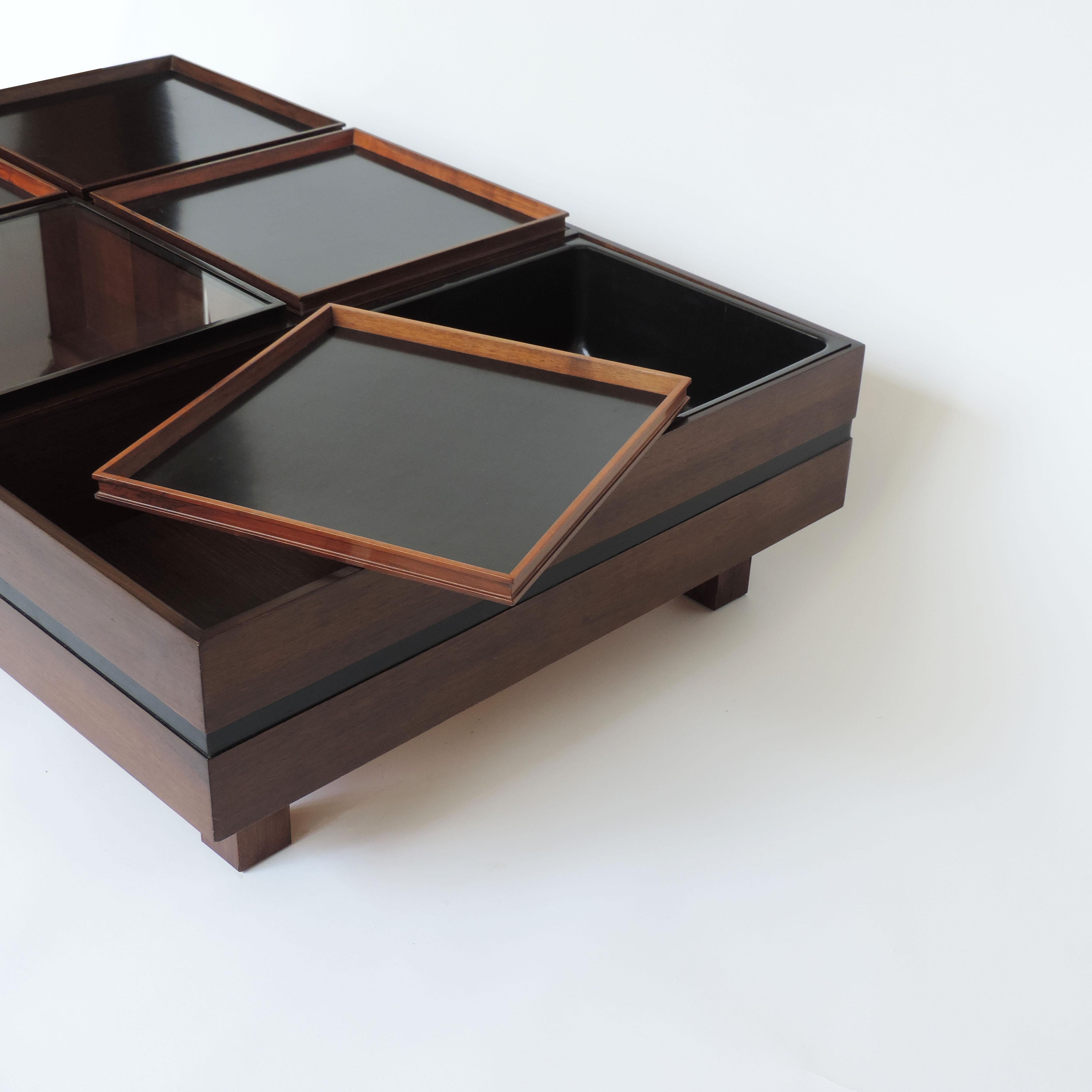 Carlo Hauner large coffee table with various compartments for Forma, Italy 1960s.
Four compartments covered with trays, one with glass which becomes a vitrine and one with a plastic container made for plants.