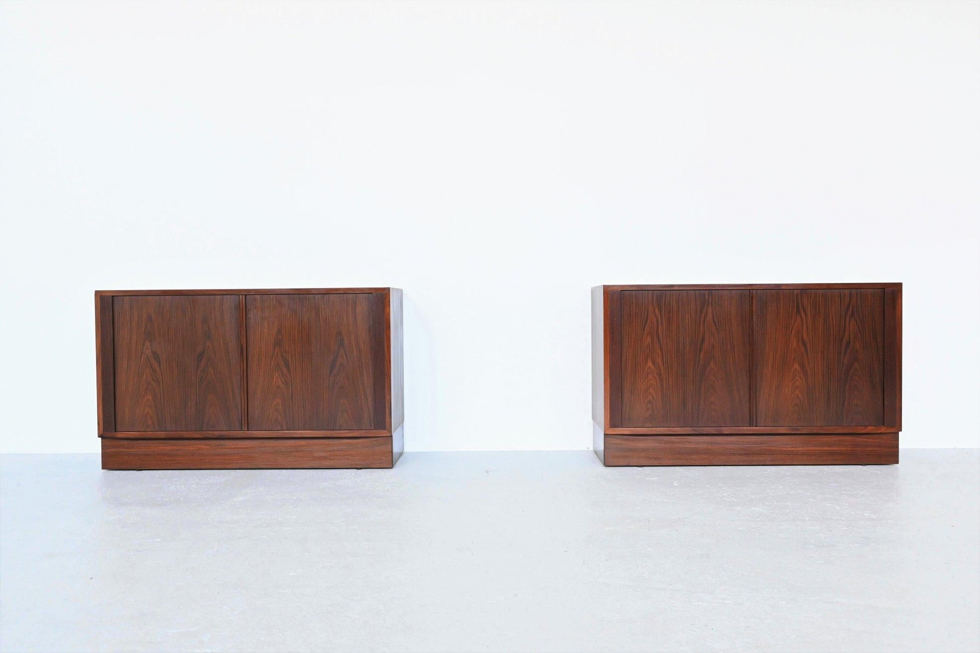 Nice pair of cabinets designed by Carlo Jensen and manufactured by Hundevad & Co, Denmark 1960. They are made of beautiful grained rosewood and have very nice sliding tambour doors with adjustable interior shelving and a drawer behind. The cabinets