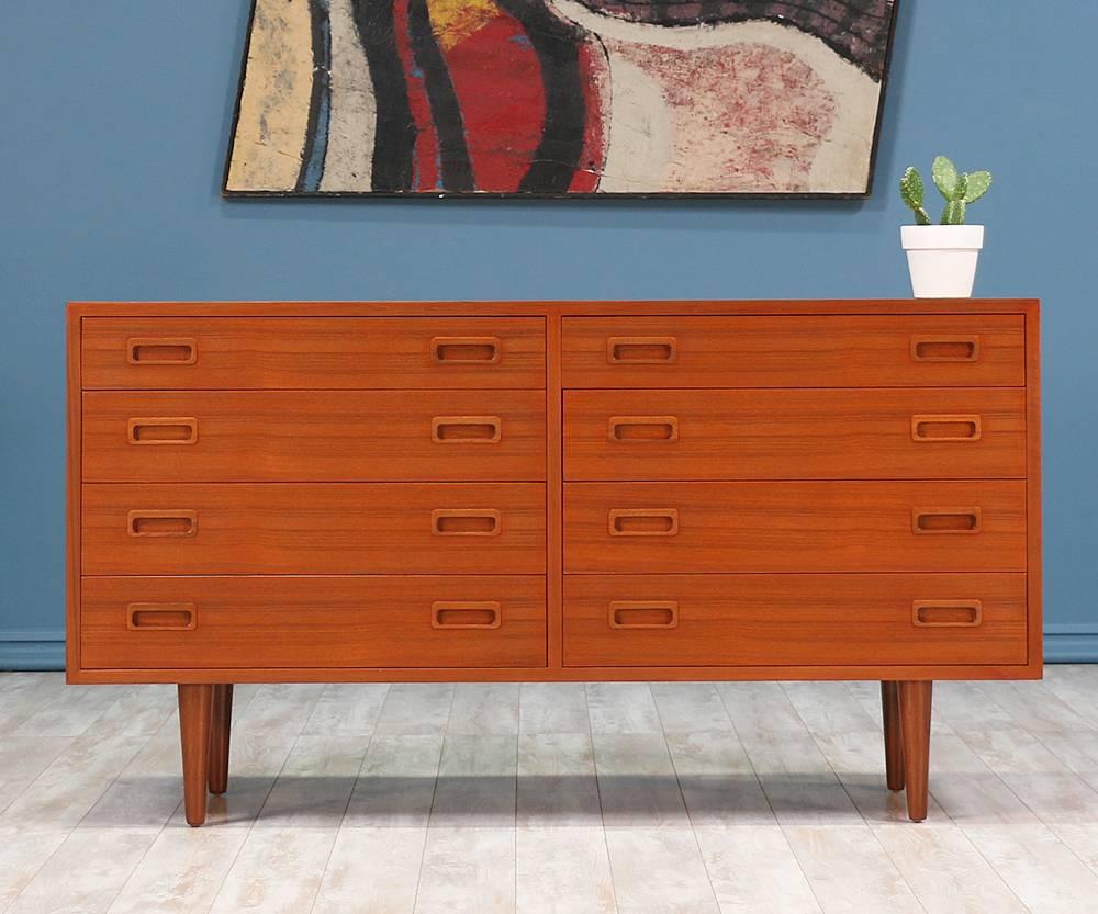 Danish modern dresser designed by Carlo Jensen in Denmark for Hundevad & Co in the 1960’s. This charming design comprised of teak features tapered legs and eight dovetailed drawers with rectangular, recessed pulls for a clean, minimalistic design.