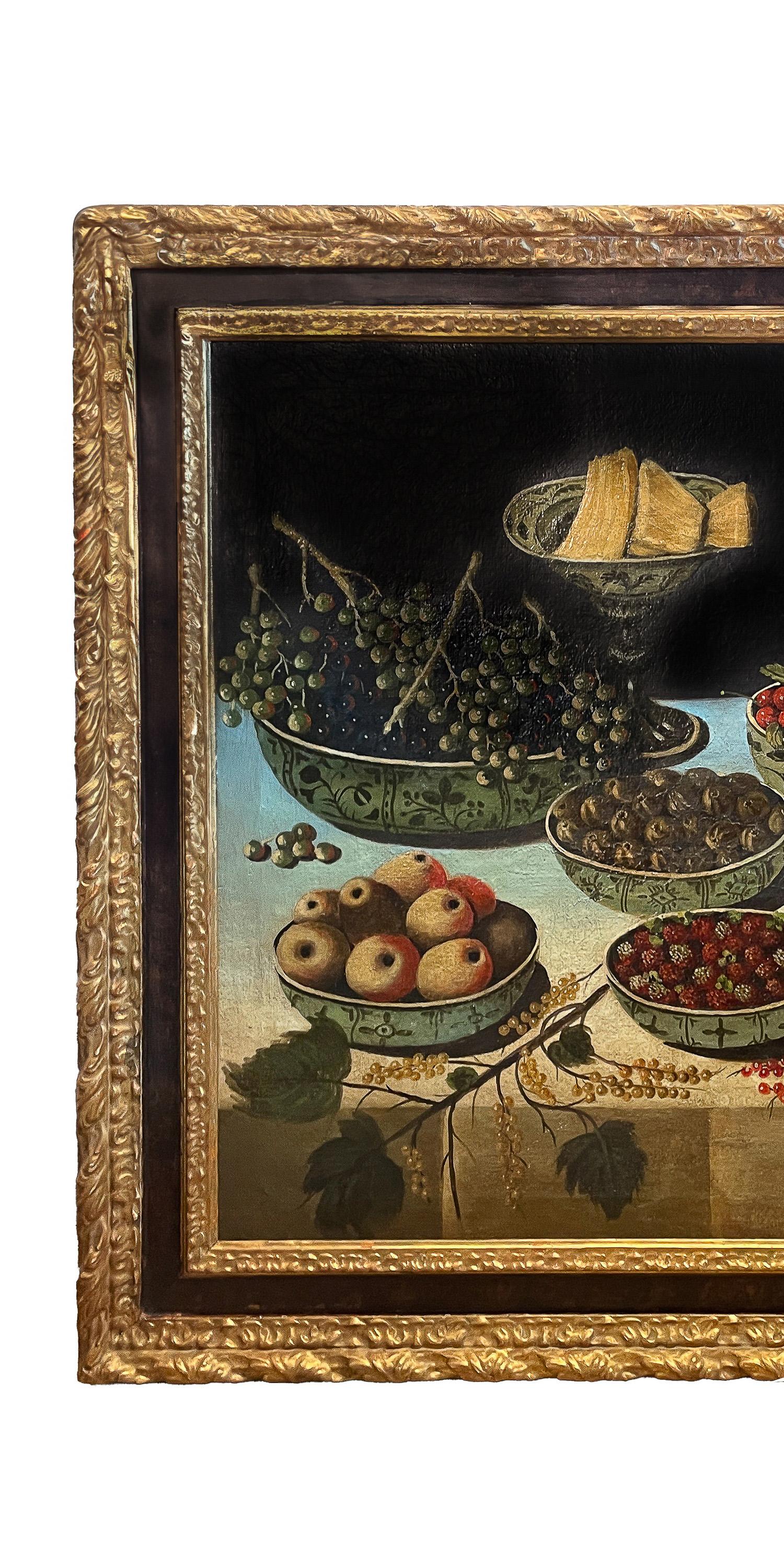 An exceptional & large antique Italian baroque still life oil on canvas painting, attributed to Carlo Magini (1720-1804), a still life scene of a table setting with bowls of fruit, circa 1780.
The painting depicts a grand table setting of 18th
