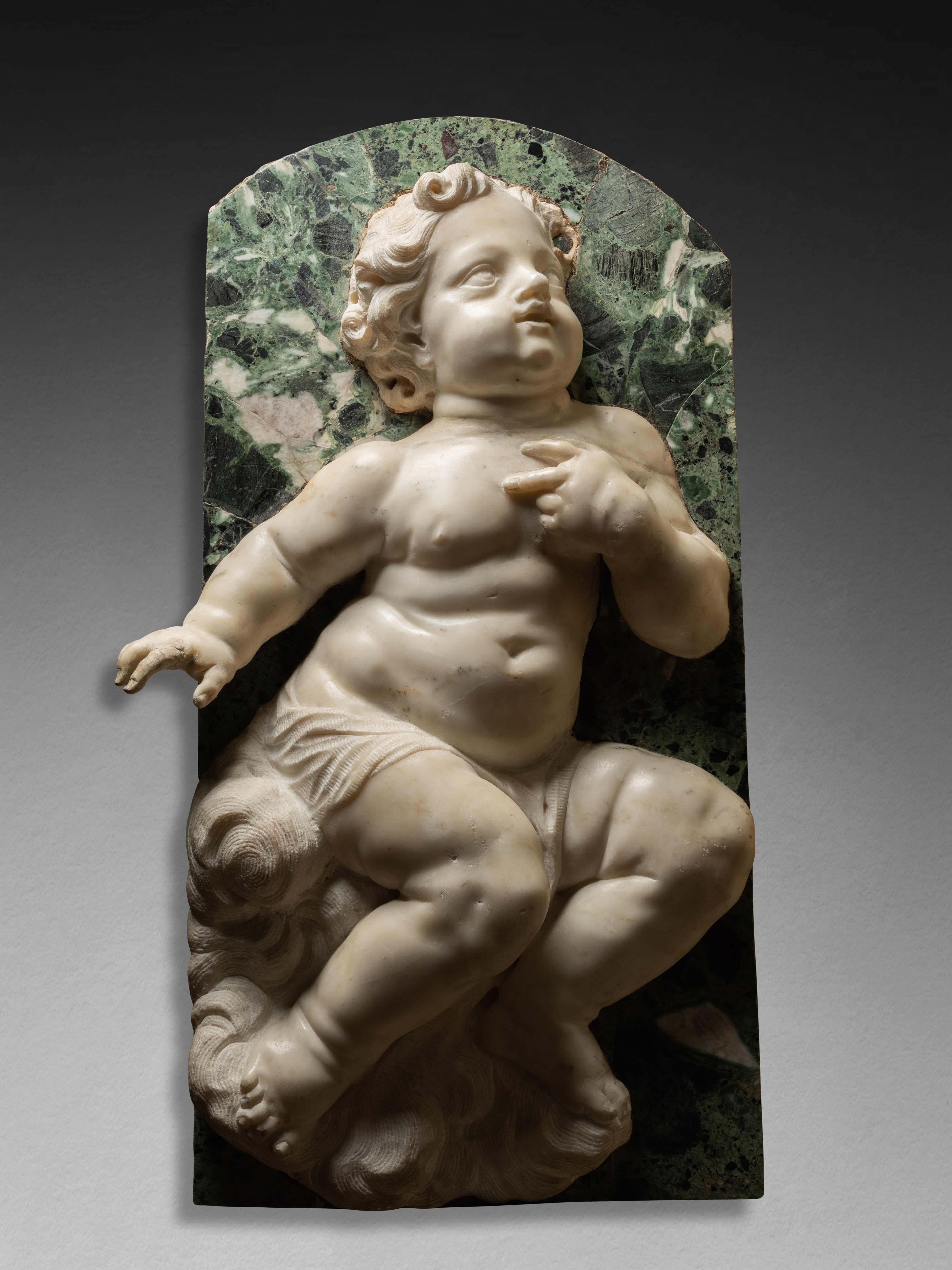 Carlo Marcellini (Florence 1644 – 1713)
Putto
White and green marble 
41.5 x 73.5 cm

This marble putto carved in high relief, almost a tutto tondo, and set on an elegant green marble background, appears almost naked, sitting on a cloud. His
