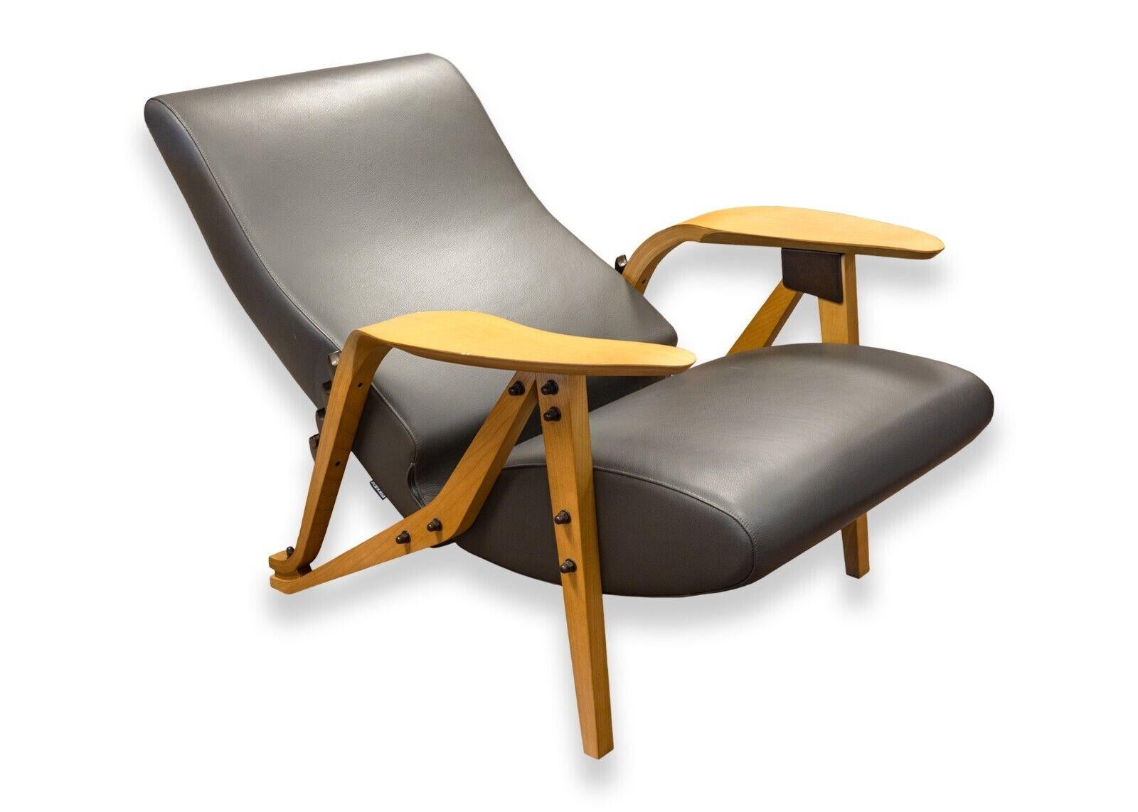 A Carlo Mollino contemporary modern grey leather Gilda lounge chair by Zanotta. A super gorgeous and unique contemporary lounge chair. This super cool accent chair features a wood frame with exposed hardware, a super luscious grey leather seat and