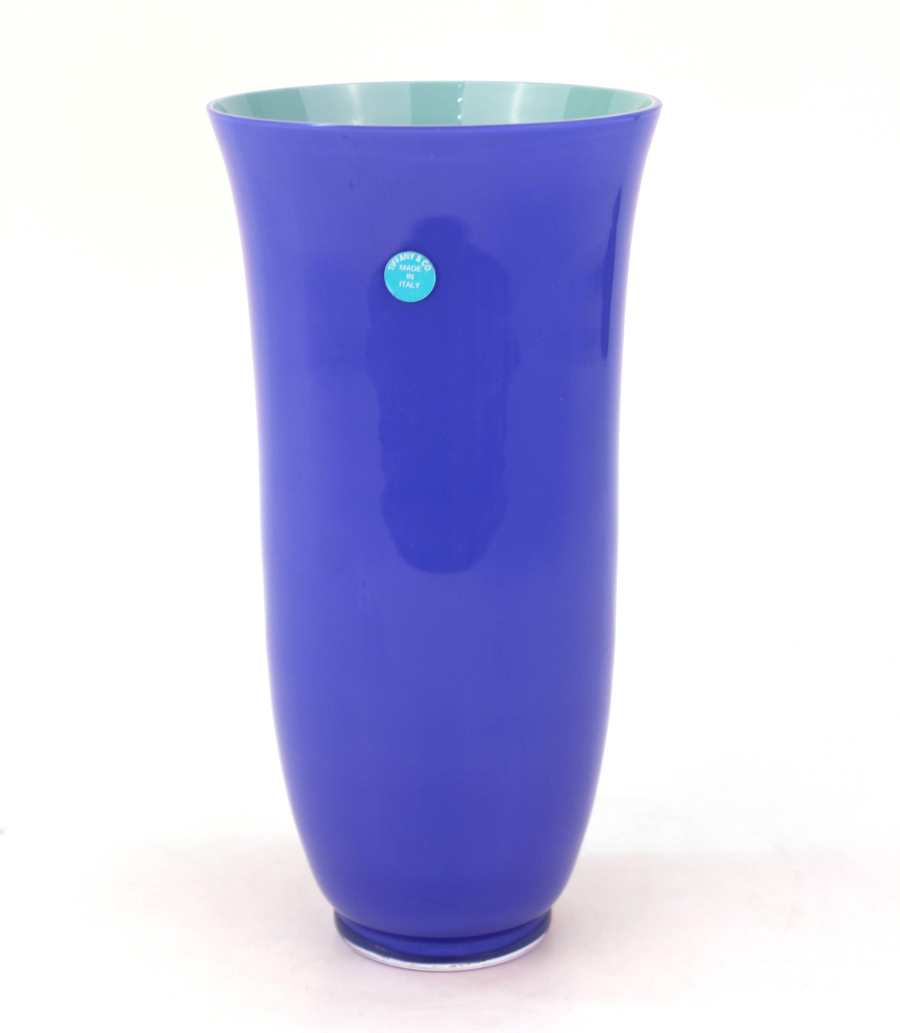 Carlo Moretti vase for Tiffany and Co. crafted in vibrant art glass. Features a violet blue exterior and aqua interior. Includes the original Tiffany & Co. label with etched signature on the bottom of the base along with [Italy]. The piece remains