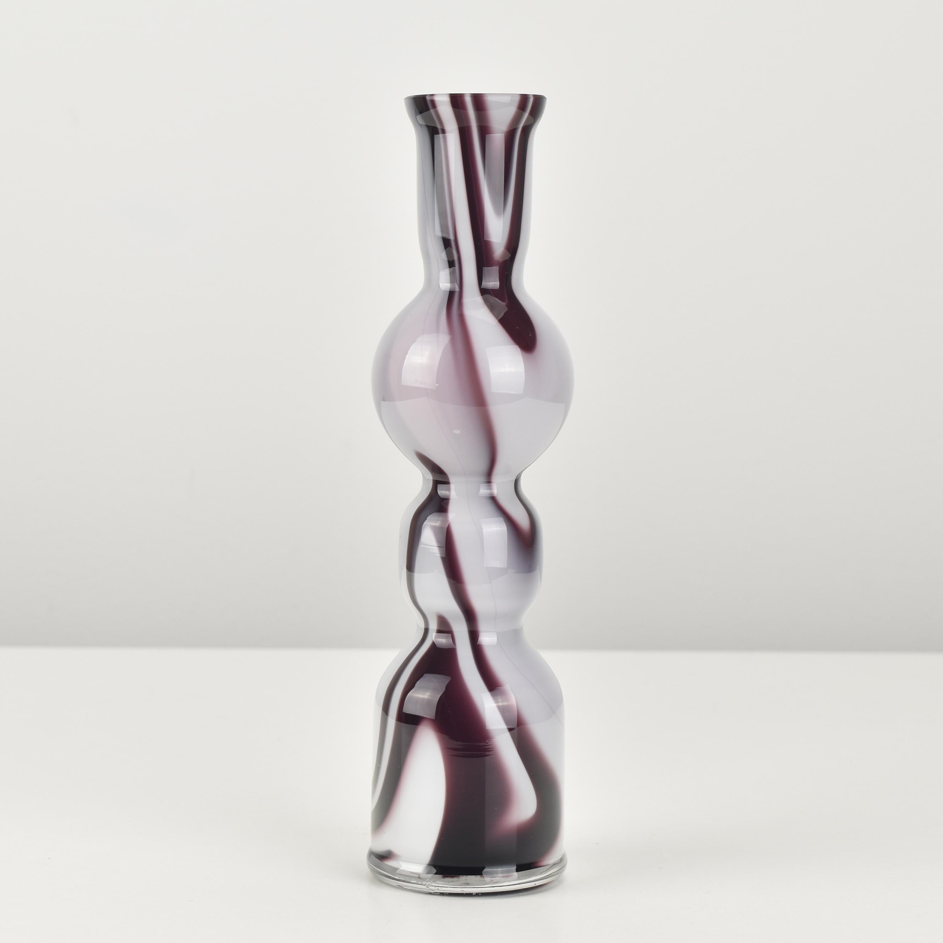 Purple and white marbled art glass vase by Carlo Moretti from the 1970s. This is a stunning piece of Venetian studio art glass that reflects the unique style and creativity of the artist. The purple and white marbled pattern creates a mesmerizing