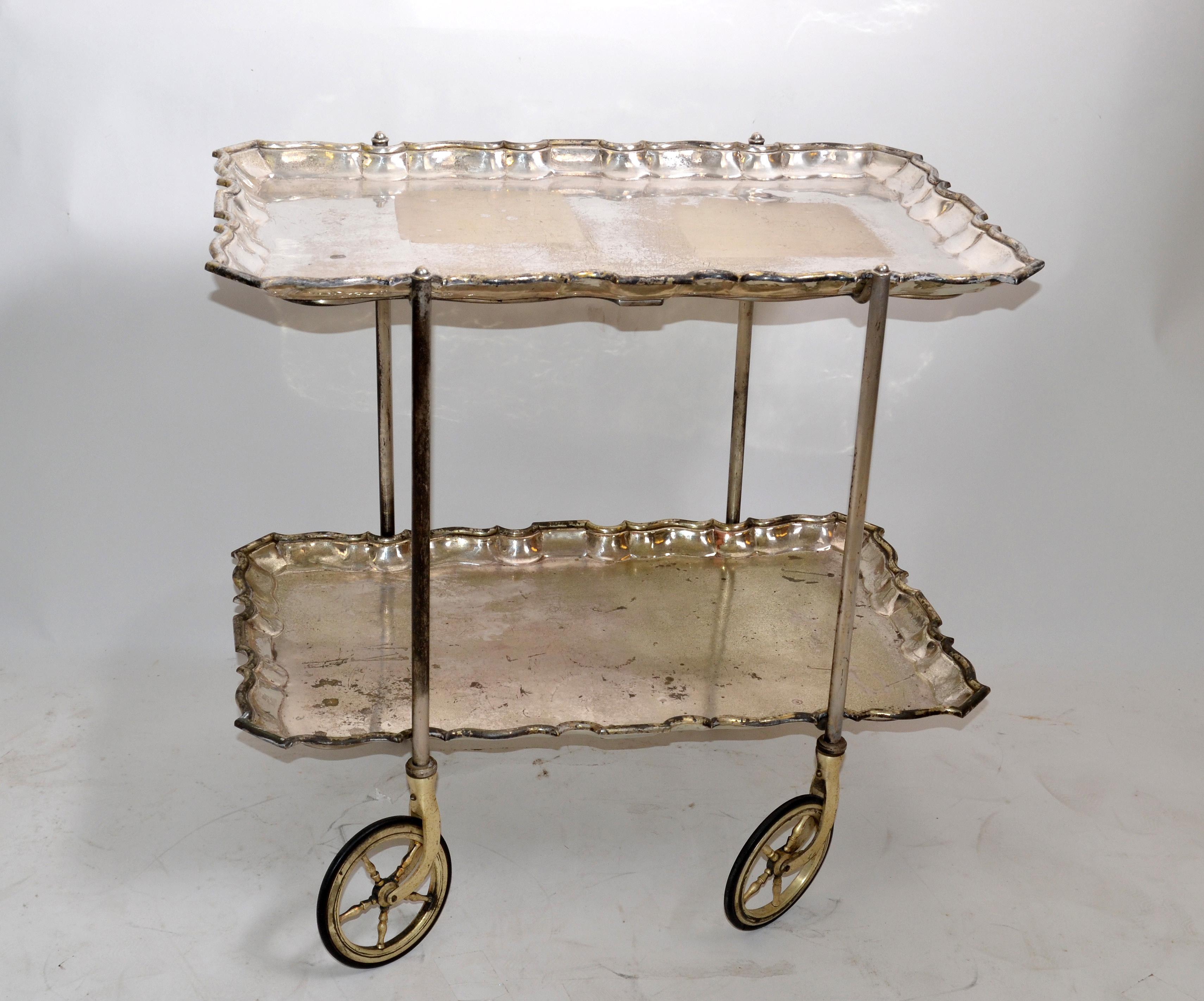 Italian neoclassical silvered two tray bar cart on the original casters from the late 60s.
Designed by Carlo Mozzoni and made in Milano.
Stamped at the base and numbered 3265.
All original distressed look but functional and sturdy, wheels run
