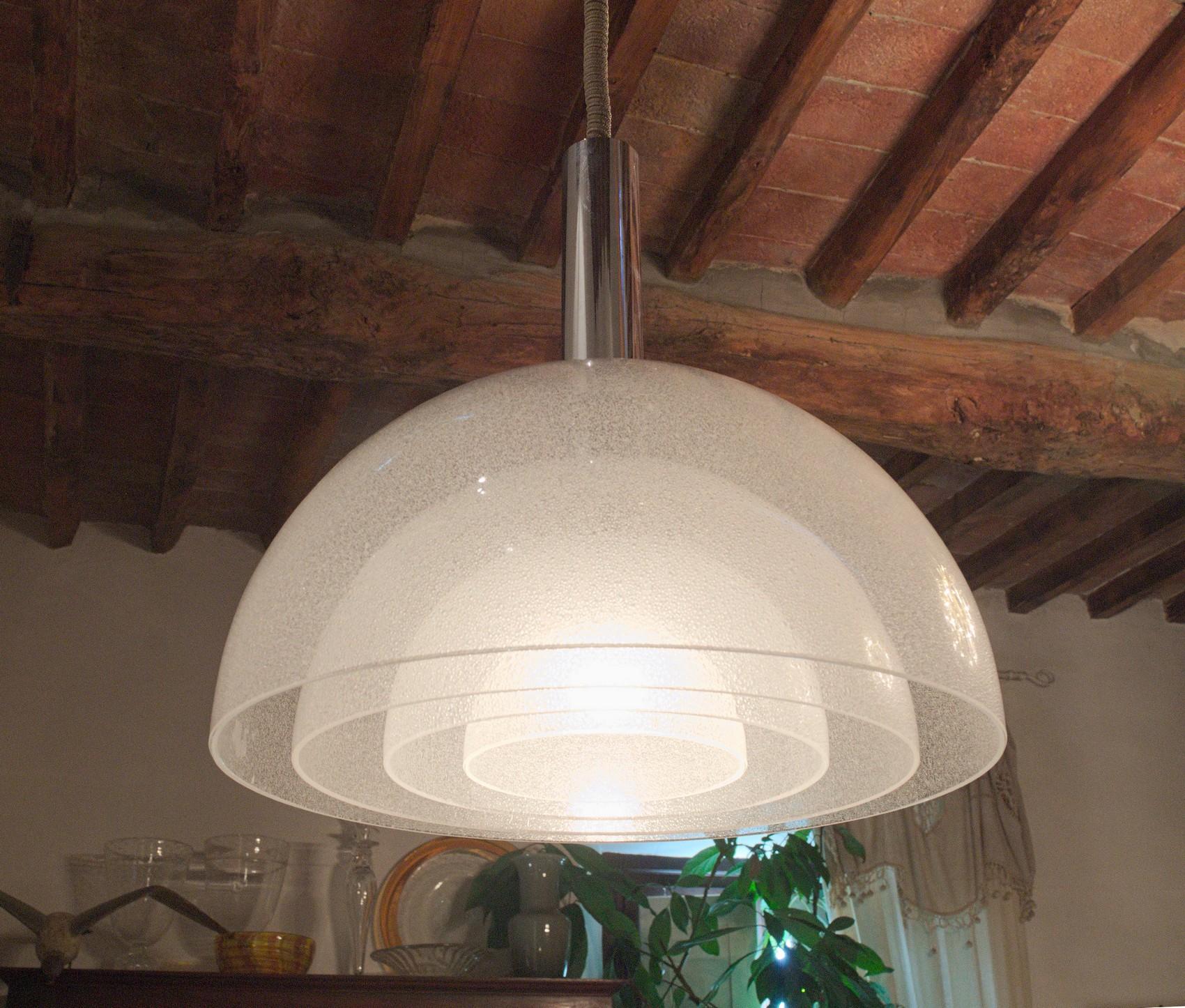 An ingenious elegant chandelier from Carlo Nason. This is the version in Pulegoso. Similar to the opaline version, the four glass pieces creates a great layering effect. From a designer who knows well light and glass. Carries the original hardware