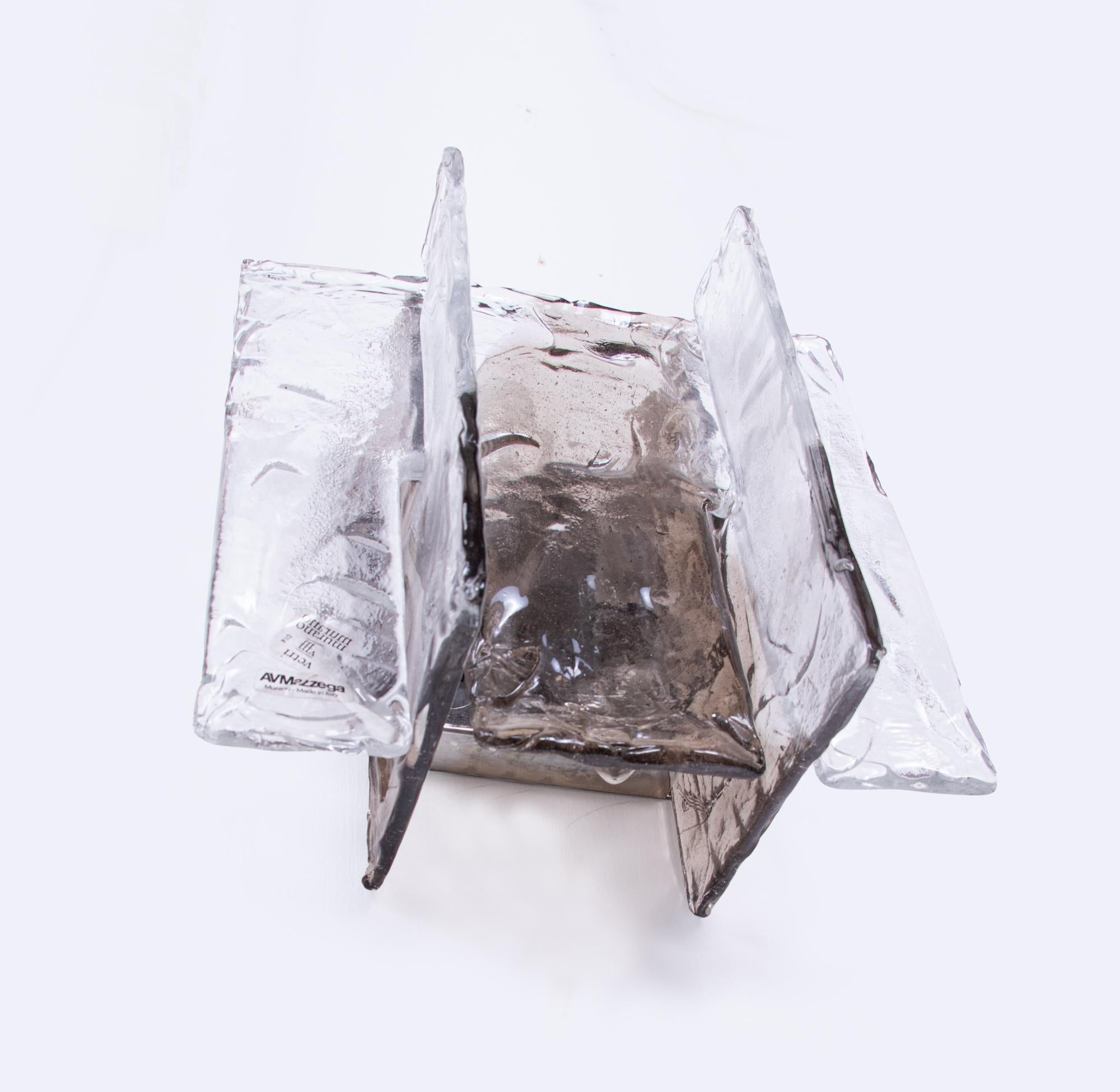Elegant Mazzega wall sconce made of handblown amber and clear Murano glass mounted on a chromed back plate. Sconce illuminates beautifully and offers a lot of light. Gem from the time. With this light you make a clear statement in your interior