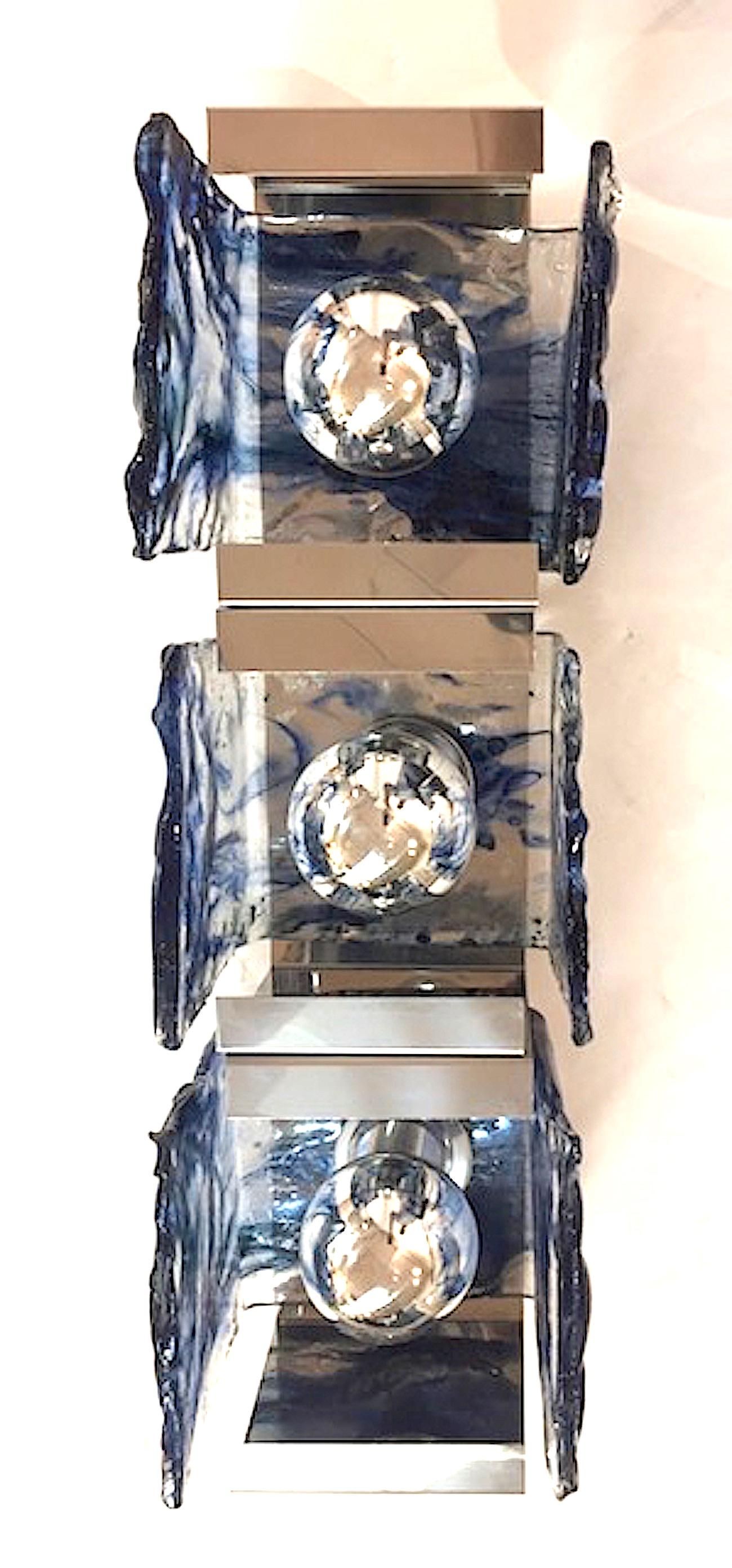 A beautiful and architectural pair of chrome mount and glass shade sconces by Carlo Nason for well known Italian lighting company Mazzega. Three hand formed clear with blue glass square 
