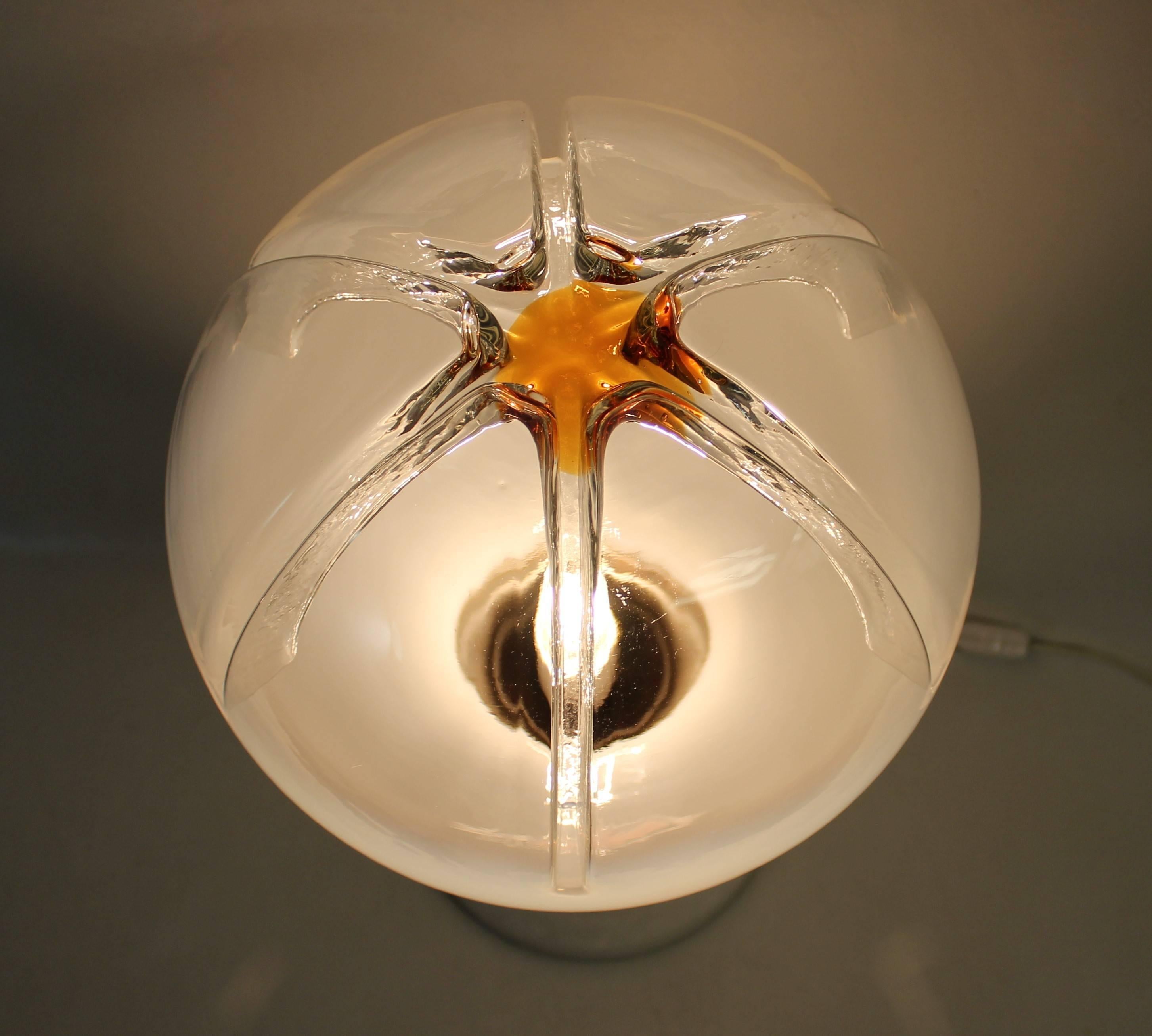 Mid-Century Modern Murano lamp featuring a milky glass and orange-tipped blown glass globe set in a chrome-plated structure with polished wood and marble base.