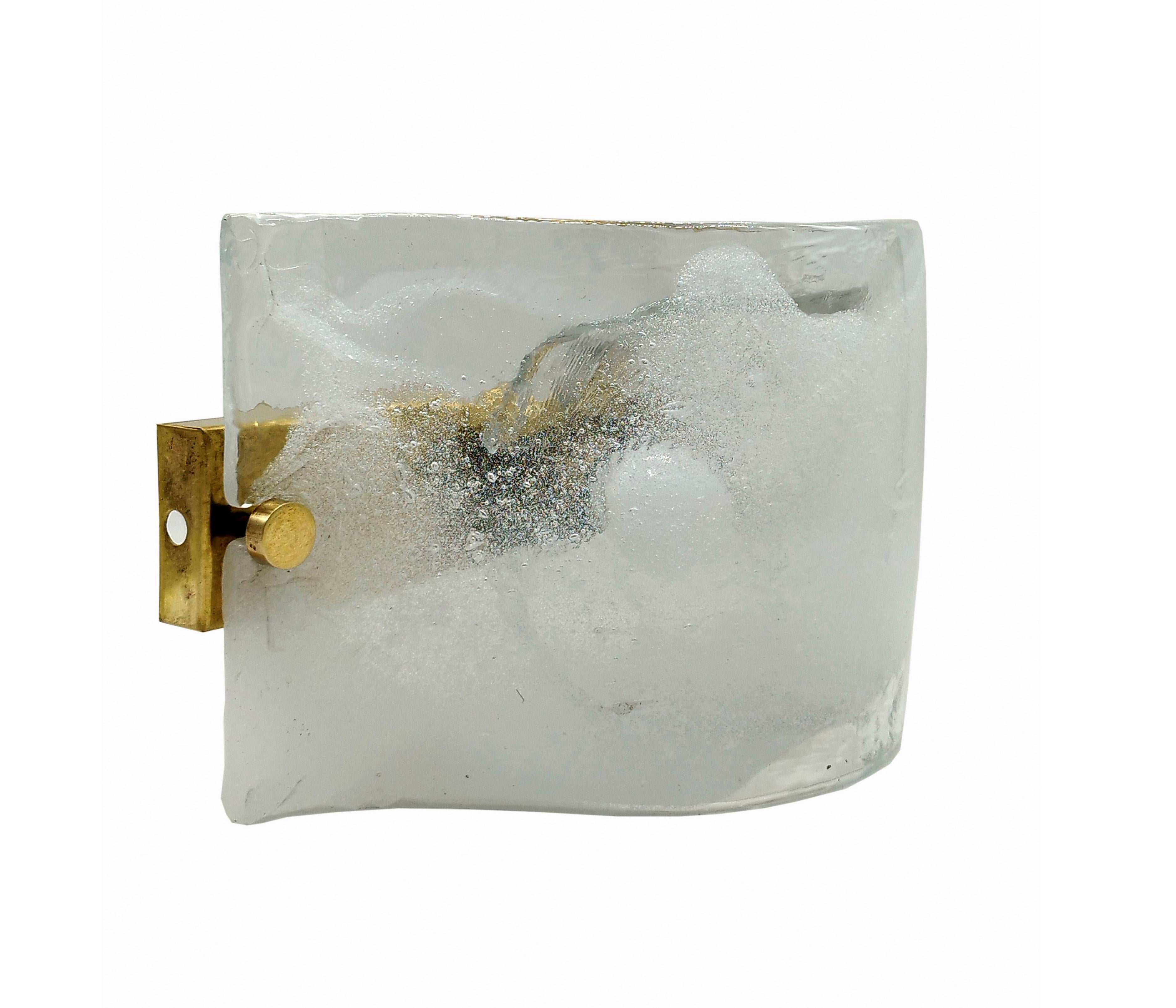 Carlo Nason for Mazzega, white hot-worked glass wall sconce on brass base, murano, Italy, late 1960s. White fused glass wall sconce on a brass back plate. The curved glass is held on the plate by two large brass screws.