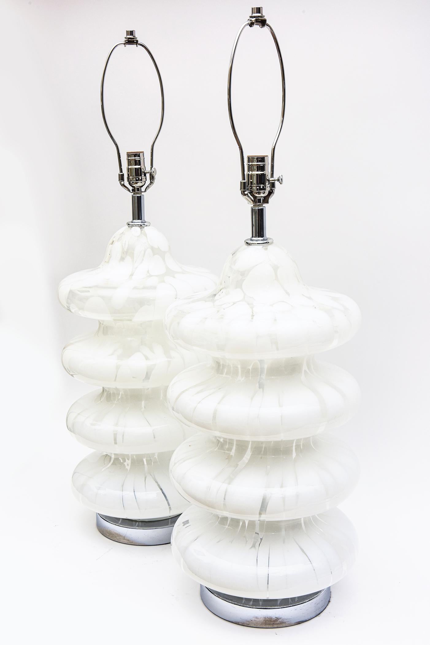 These vintage Italian 1970s Carlo Nason for Mazzega 4 tier Murano hand blown lamps are abstract patterns of mottled and random swirls of white and clear glass. They are coined the Pagoda lamps and are very iconic. They make a grand modern statement.