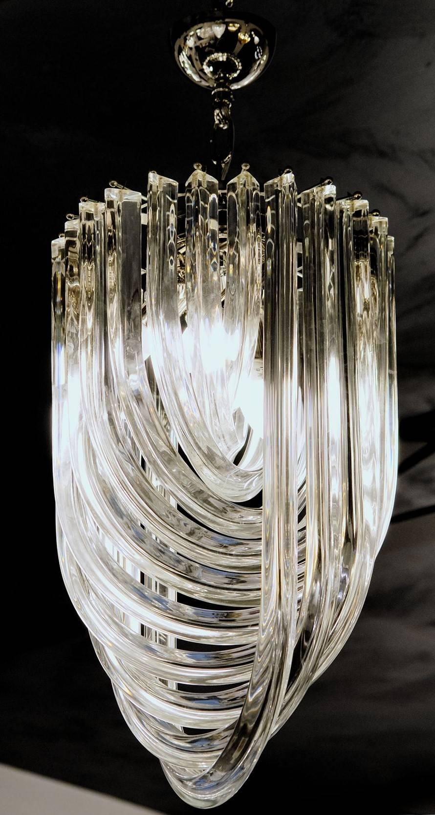 Please note price indicated is for the unit not the set.

This is a set of four masterpiece midcentury chandeliers from Murano, designed by Carlo Nason. Great play with the light. Designed in the 1970s. The use of the triedri elements had been