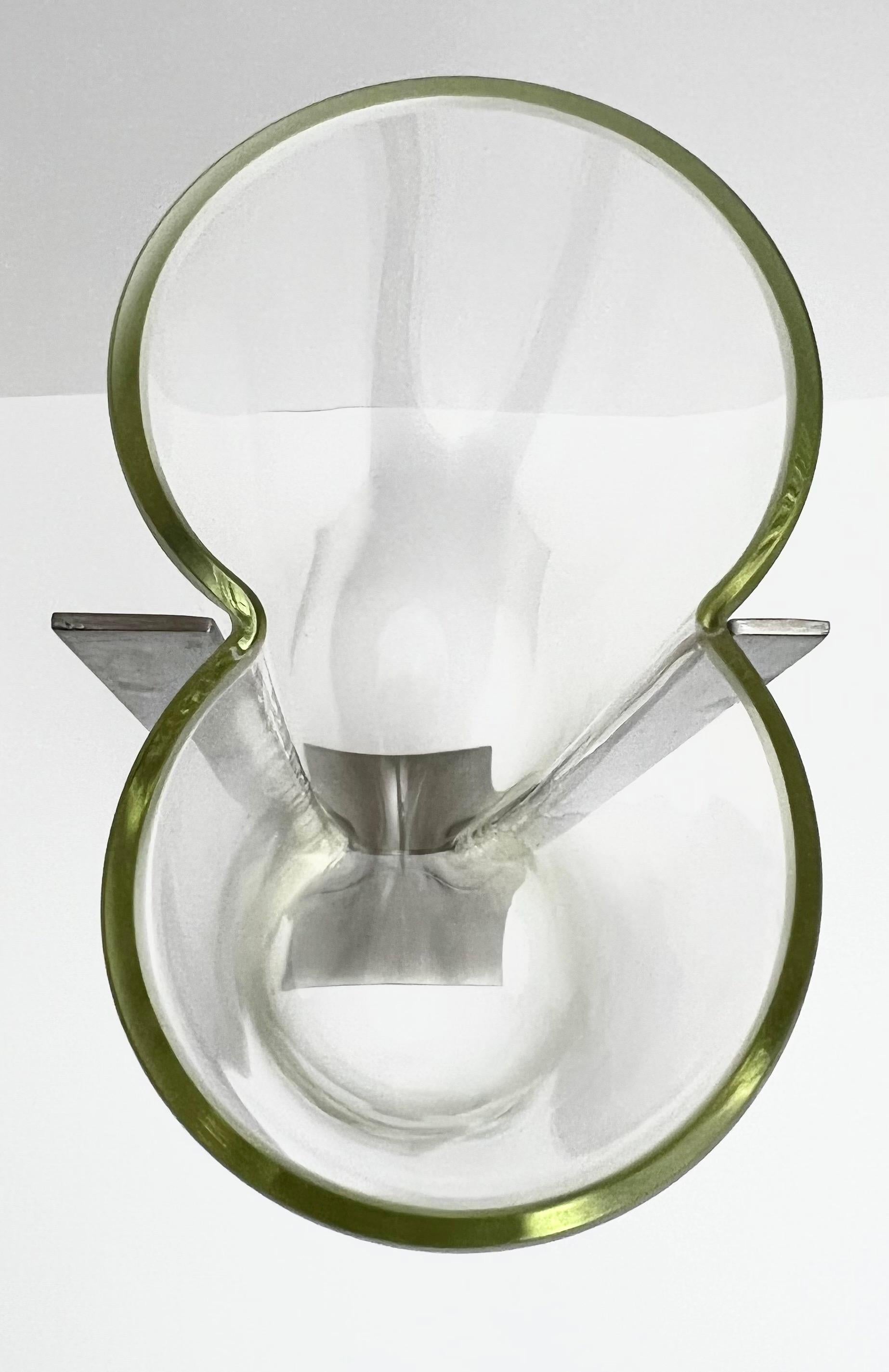 Sculpturally stunning is this Carlo Nason glass vase or sculpture set in steel, circa mid seventies. Beautiful round lines of the glass compliment the straighter edges of the stainless steel. An extraordinary juxtaposition of glass and steel. Superb