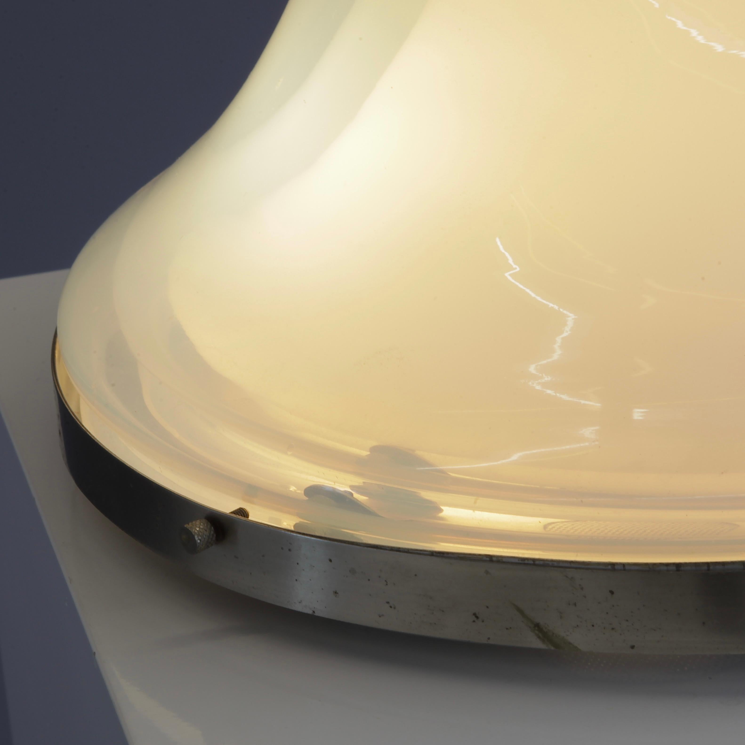 Metal base with three handblown iridescent Murano-glass pieces sitting on each other. Two E27 light fittings. The lamp was originally made as a ceiling lamp but has often been used as a table lamp. The glass pieces are perfect without any faults.