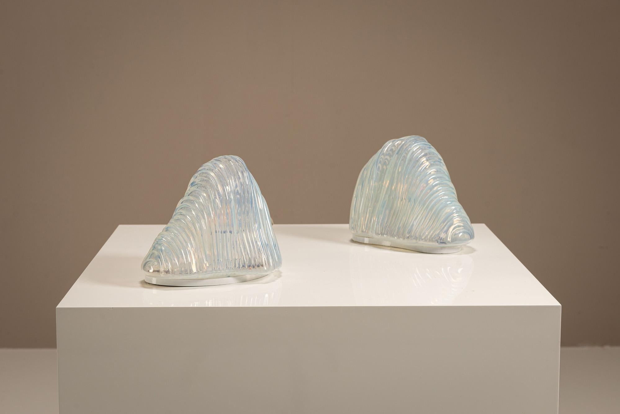 Carlo Nason’s collaborations with Mazzega resulted in some of the most intriguing sculptural lighting designs to emerge from Murano in the 20th century. This pair of LT301 “Iceberg” table lamps stands as a clear example of the meeting point between