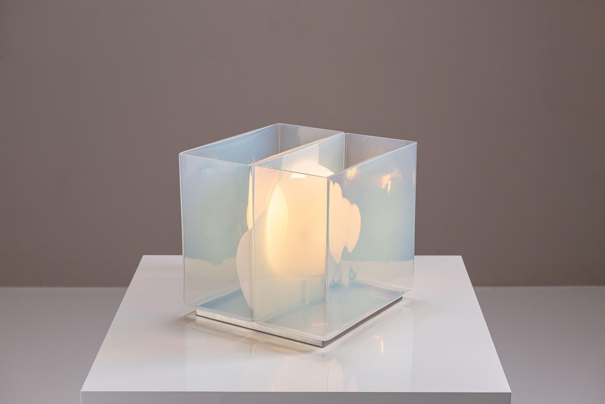 A study in material contrast and spatial interplay, this LT323 table lamp by Carlo Nason exemplifies the poetic clarity of Italian modernist lighting. Designed in the 1970s and produced by Mazzega, the piece moves beyond function to become a