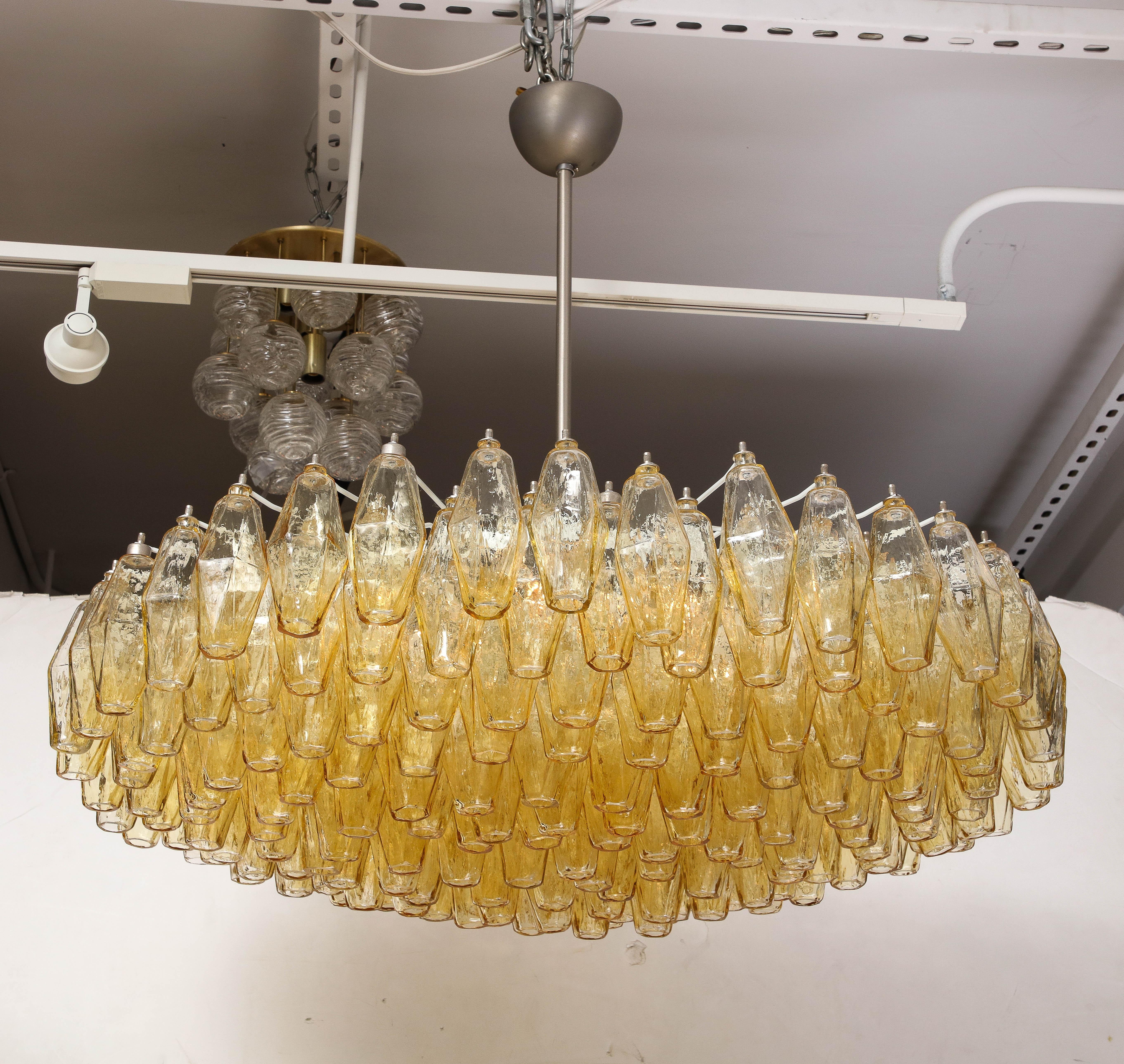 Modernist chandelier featuring multiple rows of blown glass polyhedral elements in champagne/amber/honey color suspended from a white enamel frame and satin nicklel canopy. UL listed wiring. Takes 6 edison style sockets. Carlo Scarpa for Venini